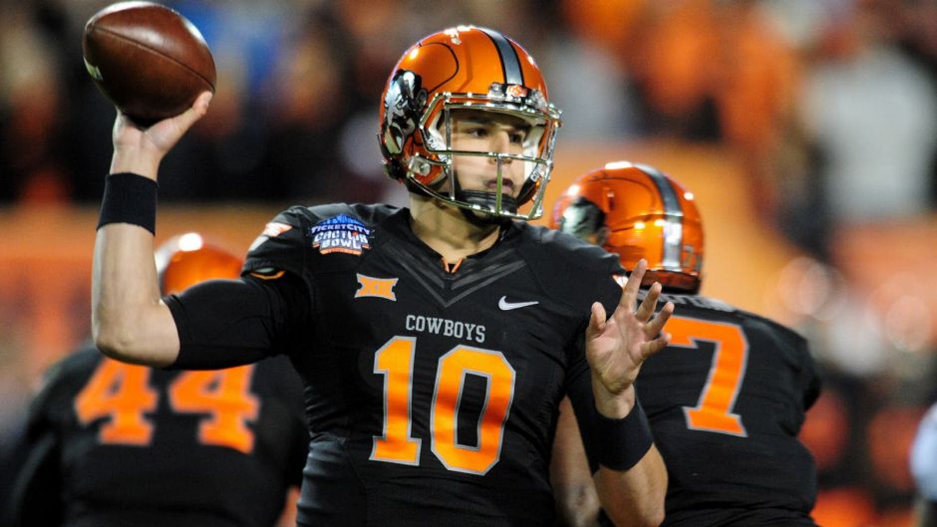 Jan 2, 2015; Tempe, AZ, USA; Oklahoma State Cowboys quarterback Mason Rudolph (10) throws during the first half against the Washington Huskies in the 2015 Cactus Bowl at Sun Devil Stadium. Mandatory Credit: Matt Kartozian-USA TODAY Sports