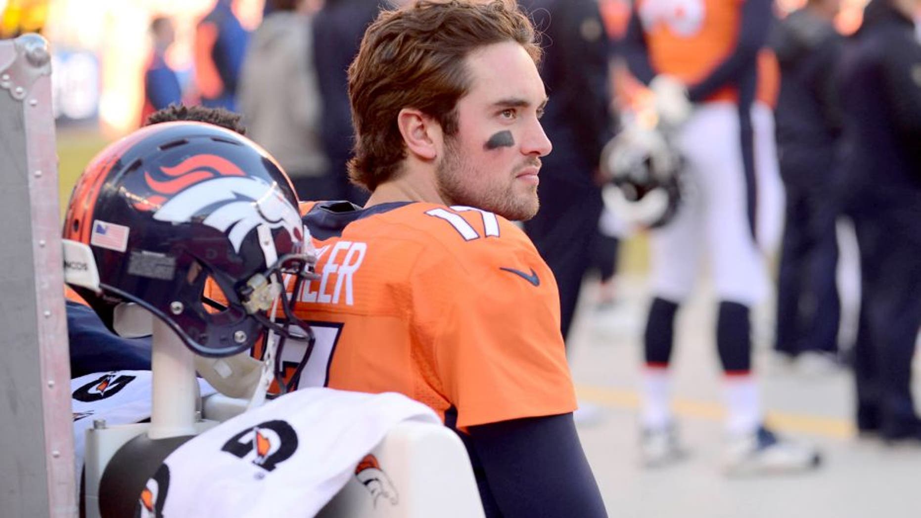Jan 3, 2016; Denver, CO, USA; Denver Broncos quarterback Brock Osweiler (17) sits on the bench in the first quarter against the San Diego Chargers at Sports Authority Field at Mile High. The Broncos defeated the Chargers 27-20. Mandatory Credit: Ron Chenoy-USA TODAY Sports