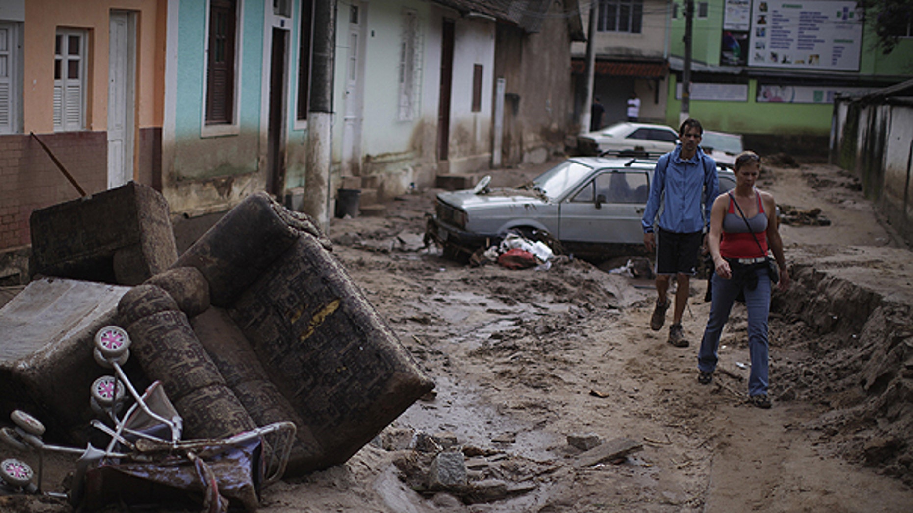 Jan. 15: People walk among debris at a street after landslides in Nova Friburgo, Brazil.