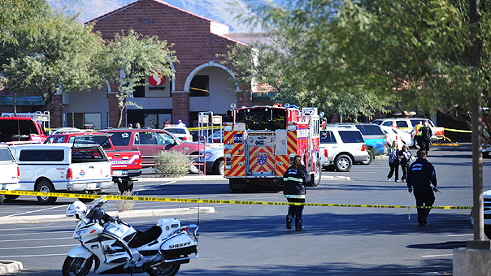 Jan. 8: Emergency officials work at the scene of a shooting that authorities claim involved Rep. Gabrielle Giffords, D-Ariz., at a Safeway grocery store in Tucson, Ariz.