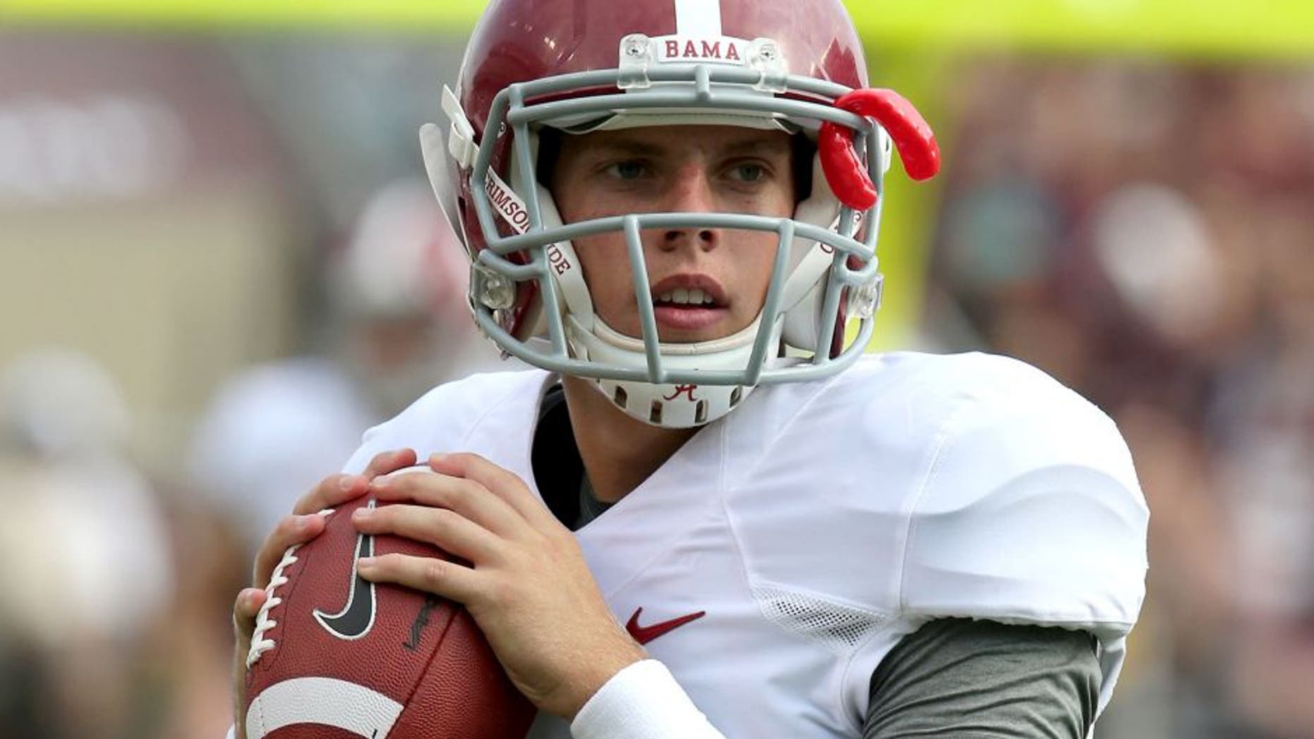 Sep 14, 2013; College Station, TX, USA; Alabama Crimson Tide quarterback Luke Del Rio (14) throws to stretch prior to the second half against the Texas A&M Aggies at Kyle Field. Mandatory Credit: Matthew Emmons-USA TODAY Sports