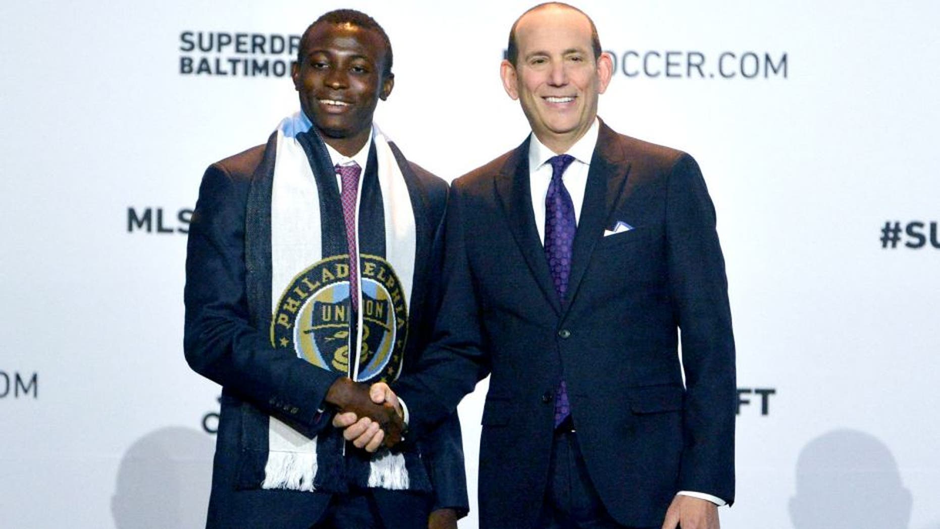 Jan 14, 2016; Baltimore, MD, USA; Joshua Yaro shakes hands with commissioner Don Garber after being selected number two overall by the Philadelphia Union during the 2016 MLS SuperDraft at Baltimore Convention Center. Mandatory Credit: Tommy Gilligan-USA TODAY Sports