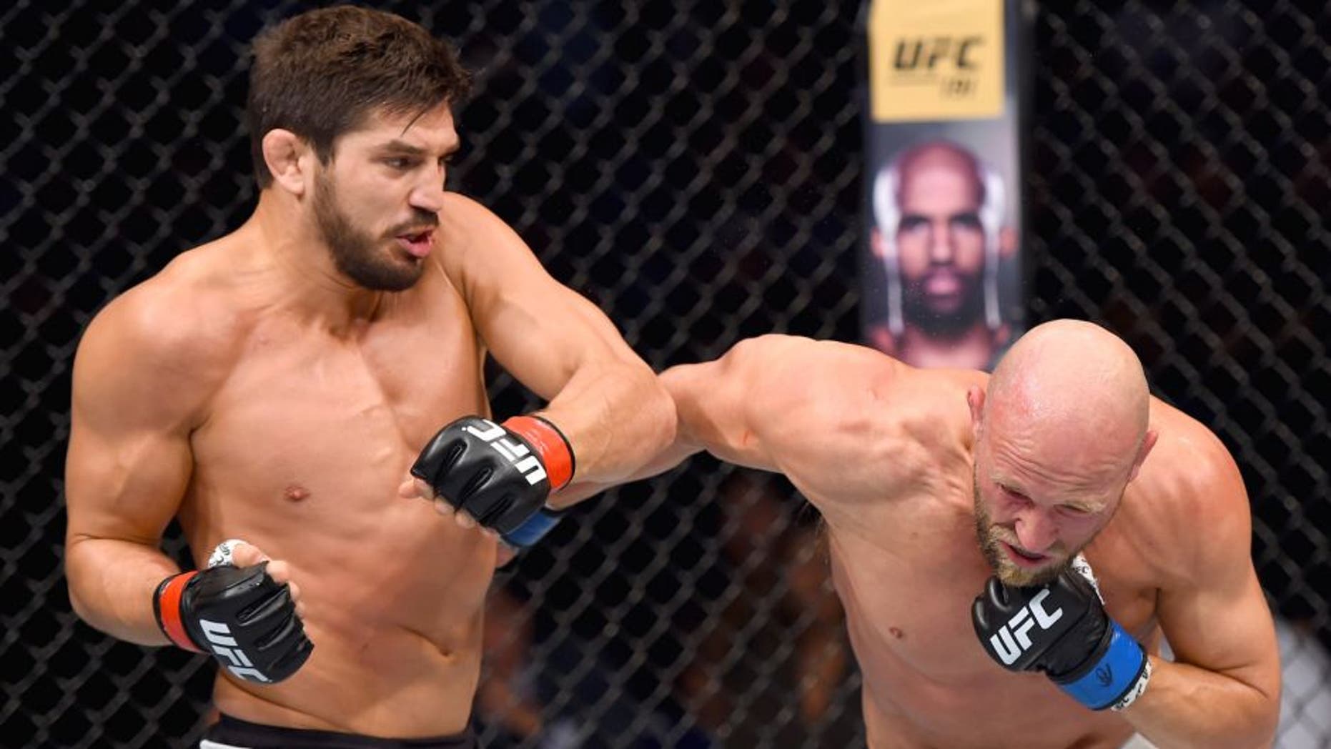 SASKATOON, SK - AUGUST 23: (L-R) Patrick Cote punches Josh Burkman of the United States in their welterweight bout during the UFC event at the SaskTel Centre on August 23, 2015 in Saskatoon, Saskatchewan, Canada. (Photo by Jeff Bottari/Zuffa LLC/Zuffa LLC via Getty Images)