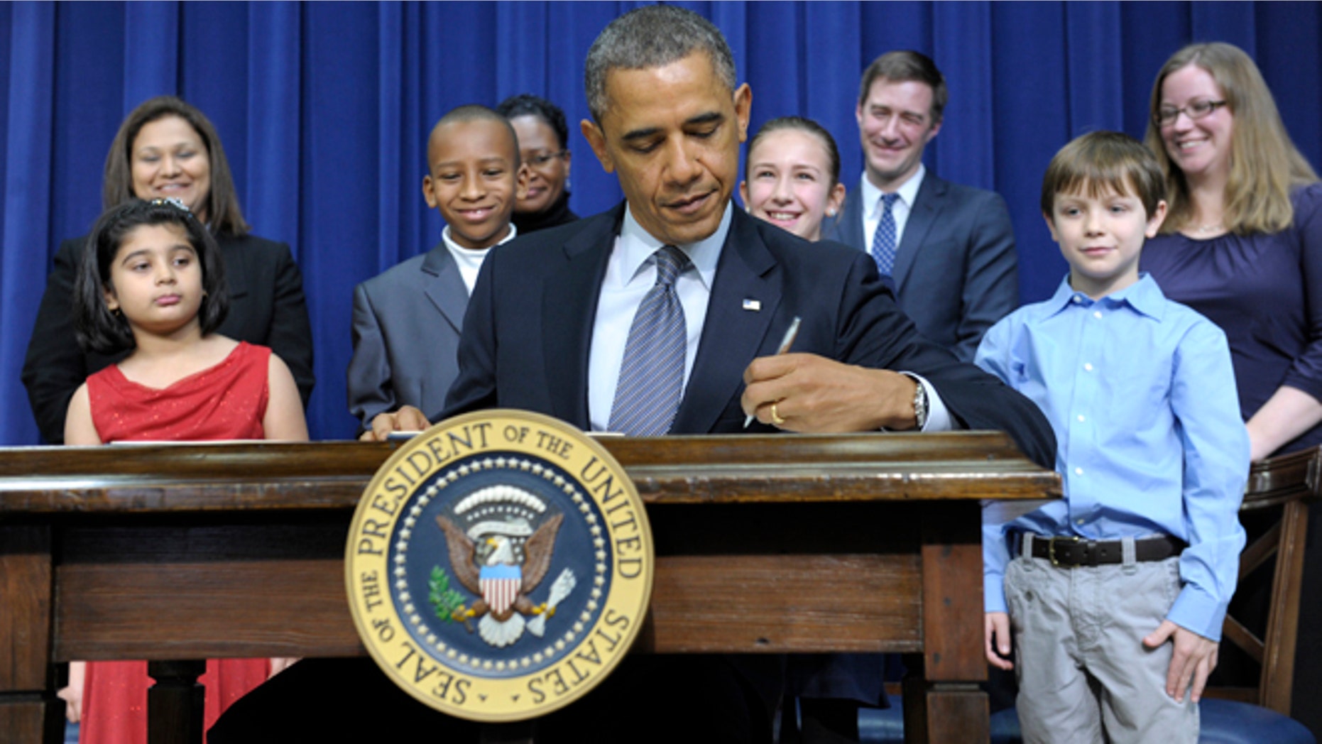 Jan. 16, 2013: President Barack Obama, accompanied by children who wrote the president about gun violence, signs executive orders.