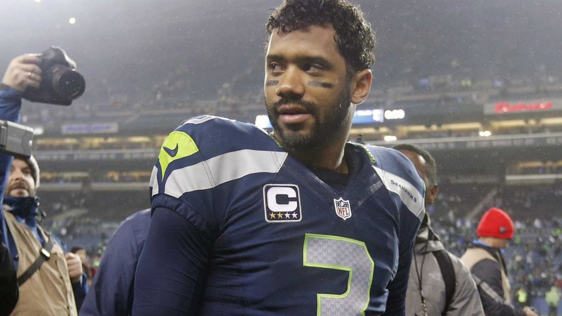 January 10, 2015; Seattle, WA, USA; Seattle Seahawks quarterback Russell Wilson (3) following the 31-17 victory against the Carolina Panthers in the 2014 NFC Divisional playoff football game at CenturyLink Field. Mandatory Credit: Joe Nicholson-USA TODAY Sports