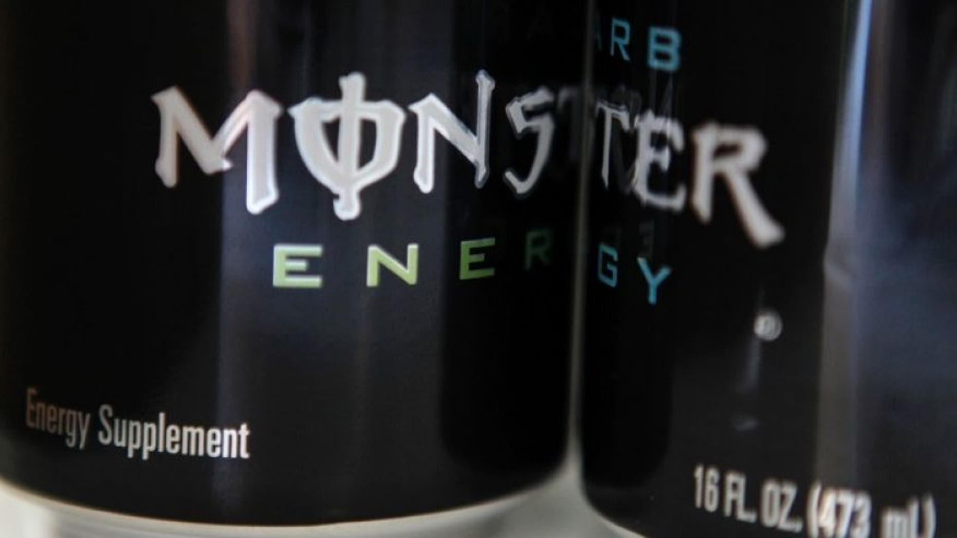 Two cans of Monster energy drink.