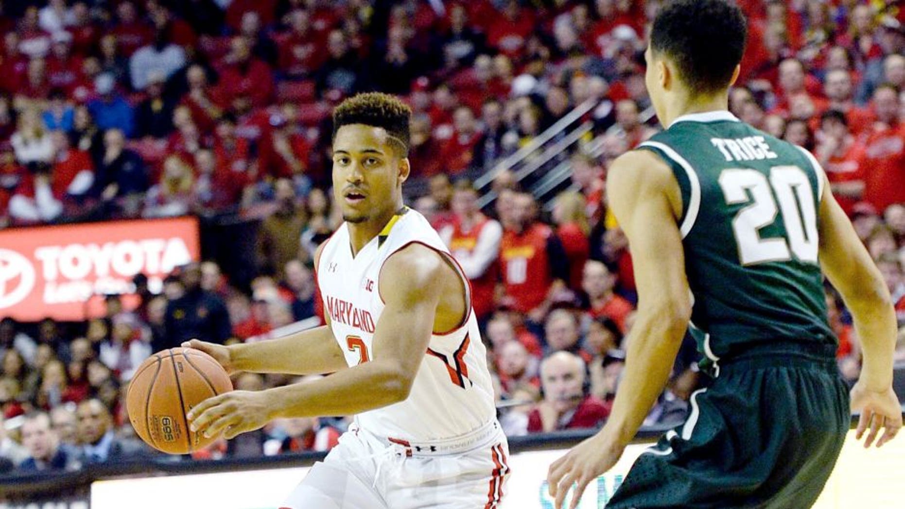 Jan 17, 2015; College Park, MD, USA; Maryland Terrapins guard Melo Trimble (2) dribbles as Michigan State Spartans guard Travis Trice (20) defends during the first half at Xfinity Center. Mandatory Credit: Tommy Gilligan-USA TODAY Sports
