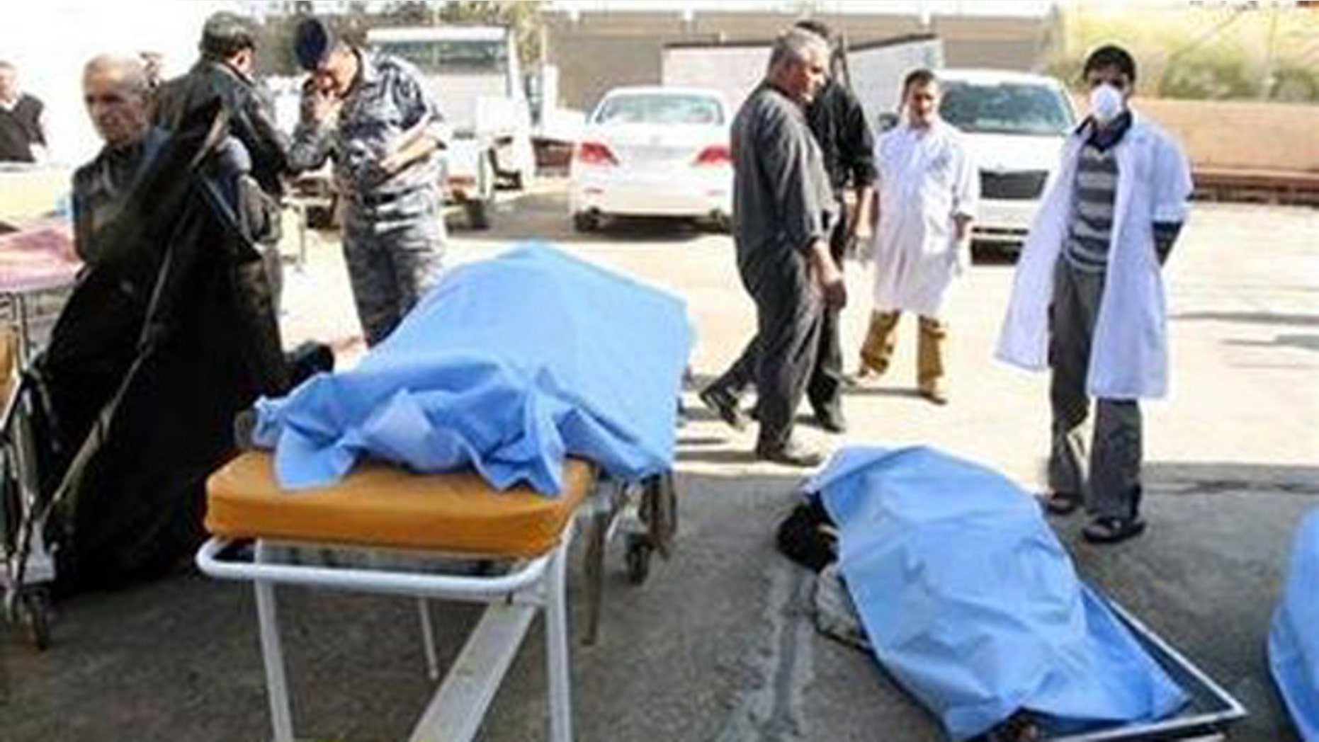 Jan. 18: Bodies of bomb attack victims are seen outside a hospital in Tikrit, some 95 miles north of Baghdad.