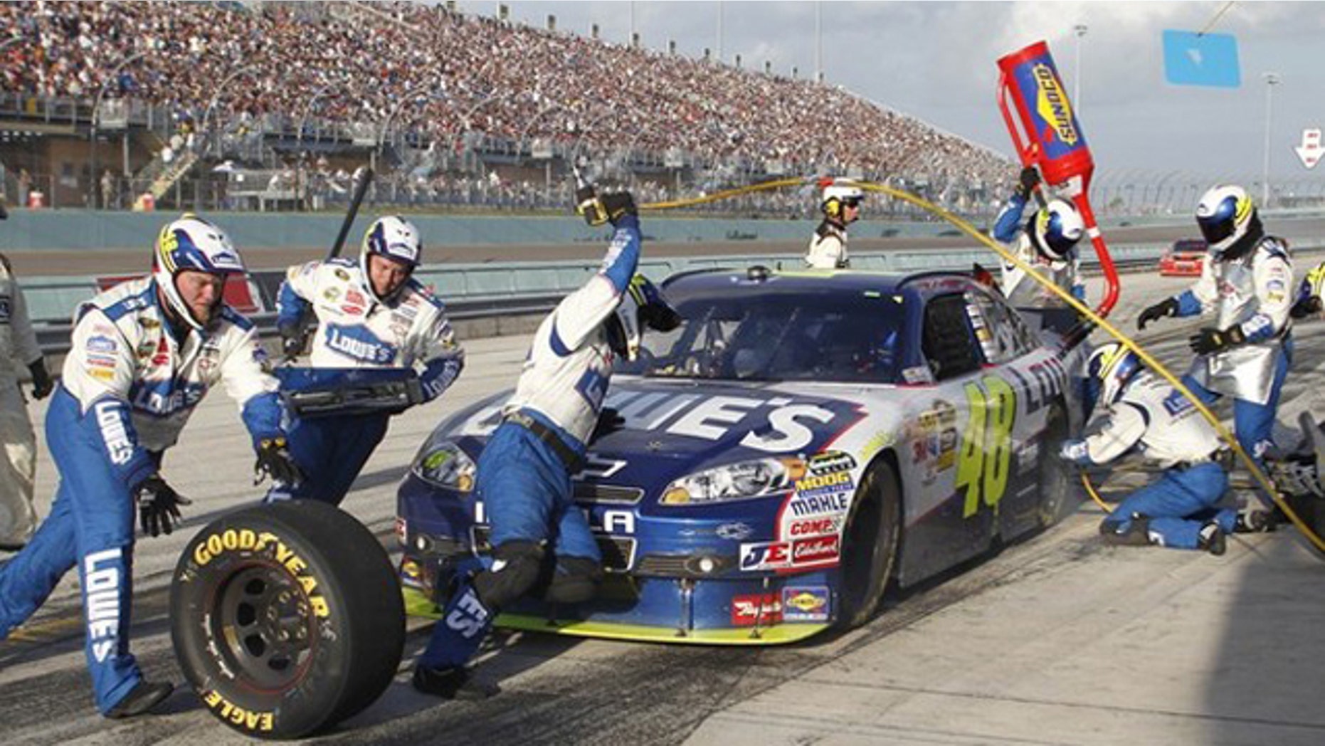 Jimmie Johnson makes a pit stop in the final laps as he won the 2010 NASCAR Sprint Cup Series championship at the Ford 400 race in Homestead, Florida November 21, 2010.