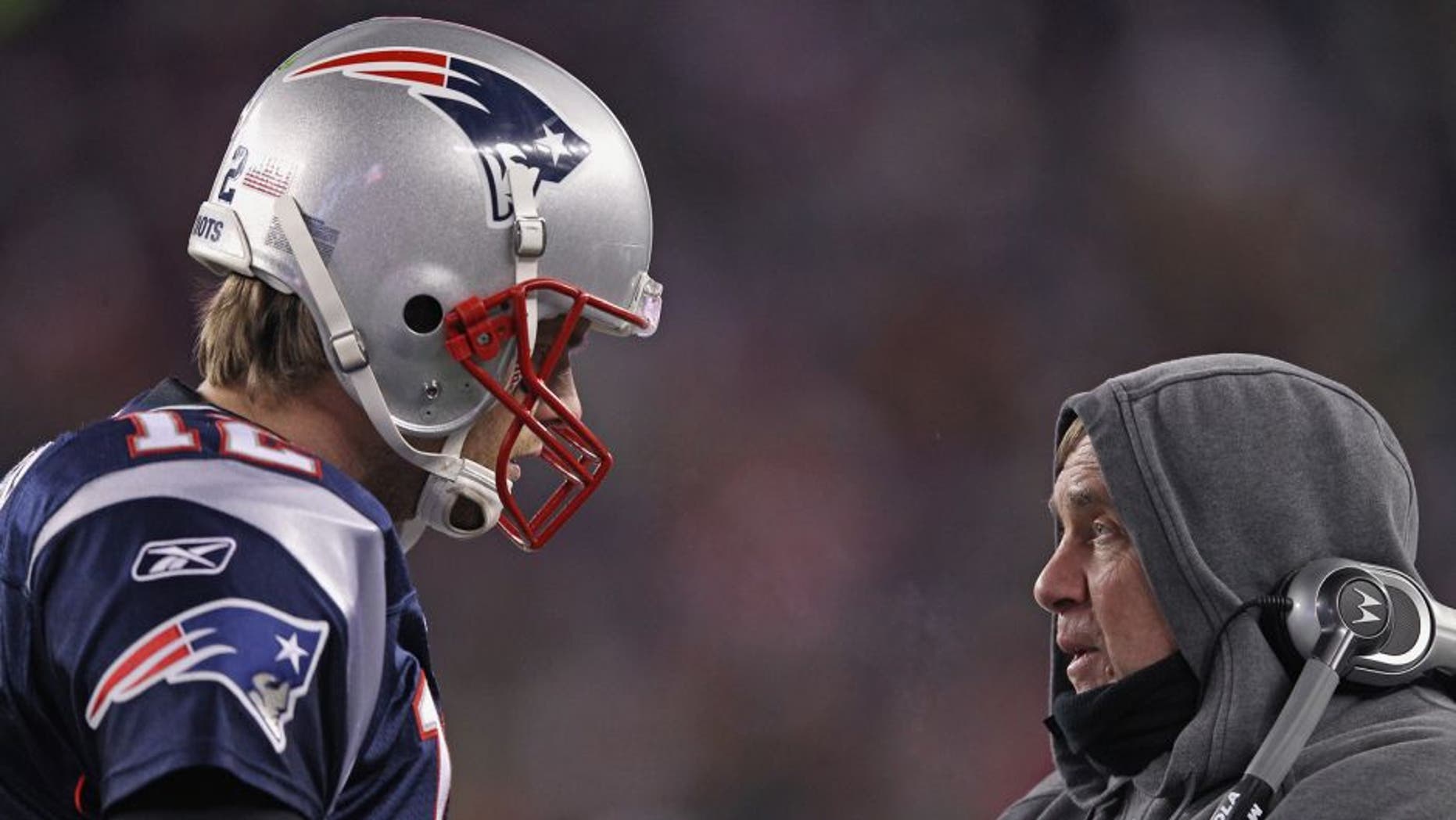 FOXBORO, MA - JANUARY 14: (L-R) Tom Brady #12 of the New England Patriots talks with head coach Bill Belichick on the sideline against the Denver Broncos during their AFC Divisional Playoff Game at Gillette Stadium on January 14, 2012 in Foxboro, Massachusetts. (Photo by Elsa/Getty Images)