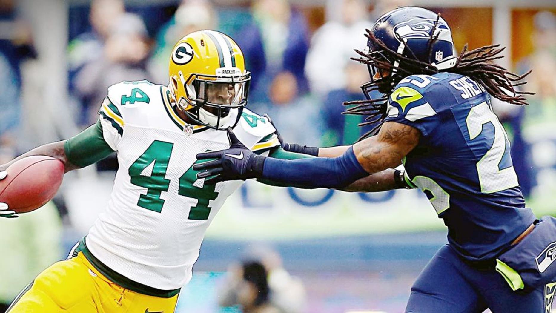 SEATTLE, WA - JANUARY 18: James Starks #44 of the Green Bay Packers gives Richard Sherman #25 of the Seattle Seahawks a stiff arm as he runs with the ball during the second half of the 2015 NFC Championship game at CenturyLink Field on January 18, 2015 in Seattle, Washington. (Photo by Tom Pennington/Getty Images)