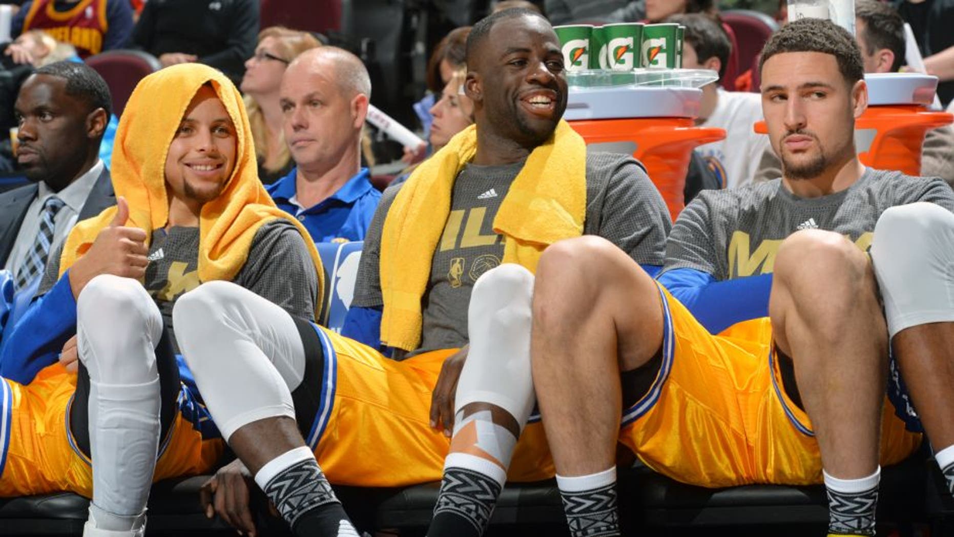 CLEVELAND, OH - JANUARY 18: Stephen Curry #30 of the Golden State Warriors smiles while resting on the bench along side Draymond Green #23 an Klay Thompson #11 against the Cleveland Cavaliers on January 18, 2016 at Quicken Loans Arena in Cleveland, Ohio. (Jesse D. Garrabrant/NBAE via Getty Images)