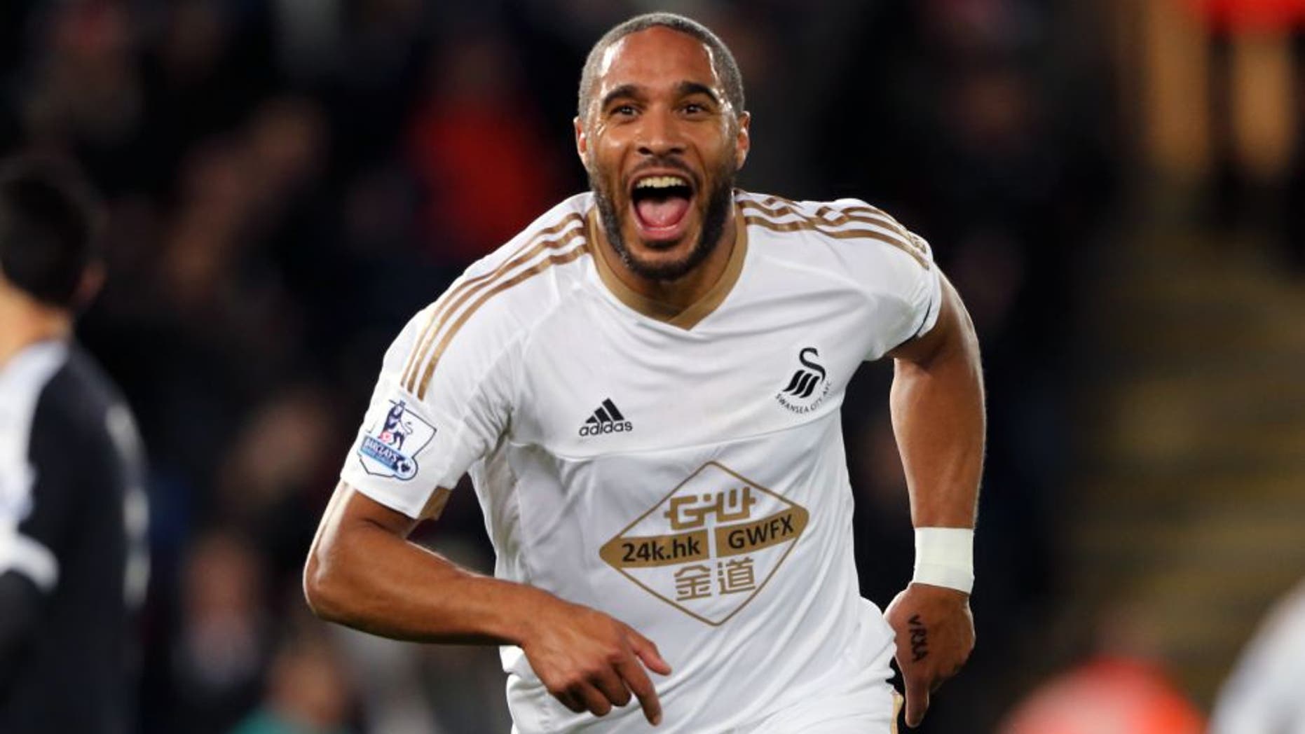 SWANSEA, WALES - JANUARY 18: Ashley Williams of Swansea City celebrates after scoring a goal to make it 1-0 during the Barclays Premier League match between Swansea City and Watford at the Liberty Stadium on January 18, 2016 in Swansea, Wales. (Photo by Matthew Ashton - AMA/Sports Photo Agency)