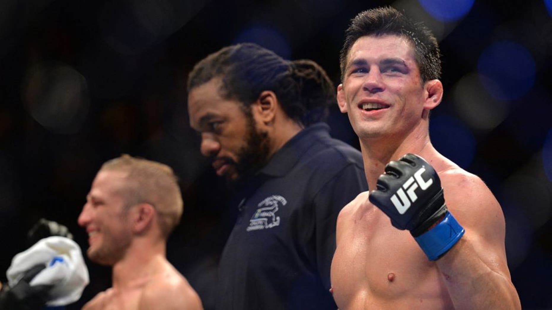 BOSTON, MA - JANUARY 17: (R-L) Dominick Cruz and TJ Dillashaw wait to hear the judges decision after in their UFC bantamweight championship bout during the UFC Fight Night event inside TD Garden on January 17, 2016 in Boston, Massachusetts. (Photo by Brandon Magnus/Zuffa LLC/Zuffa LLC via Getty Images)