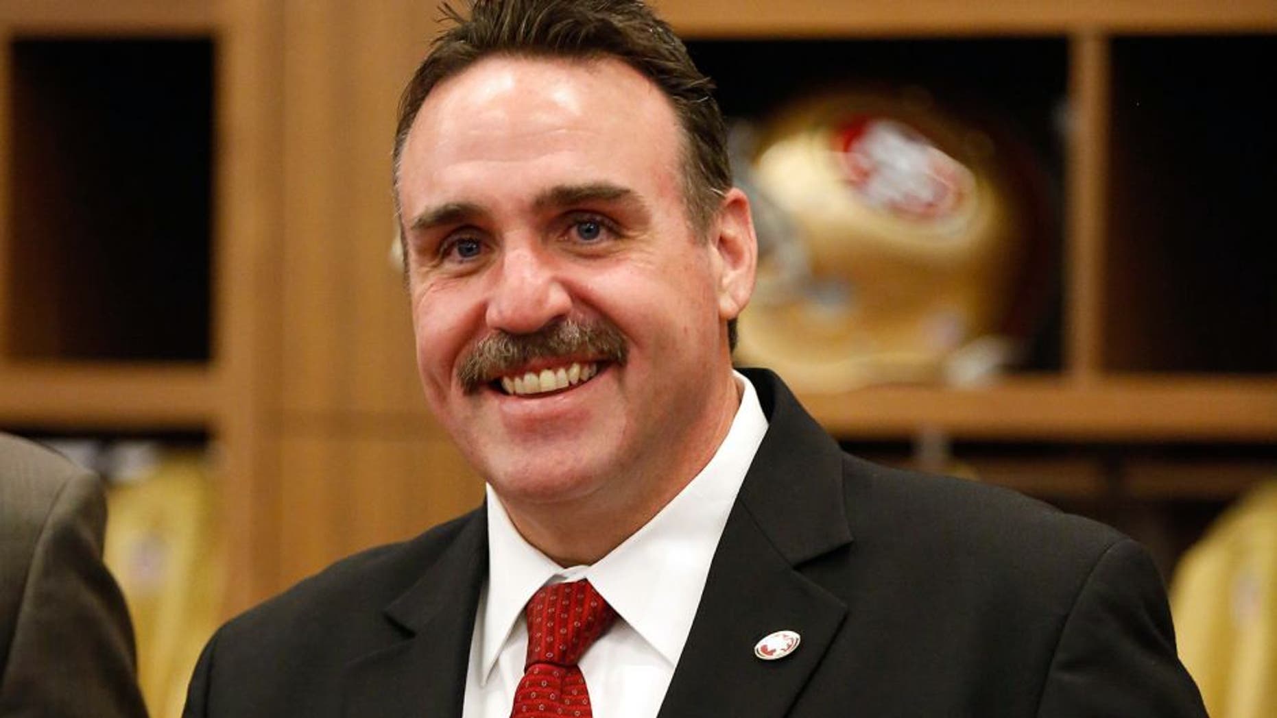 Jan 15, 2015; Santa Clara, CA, USA; San Francisco 49ers head coach Jim Tomsula poses for a photo in the locker room after a press conference for his introduction as head coach at Levi's Stadium Auditorium. Mandatory Credit: Kelley L Cox-USA TODAY Sports