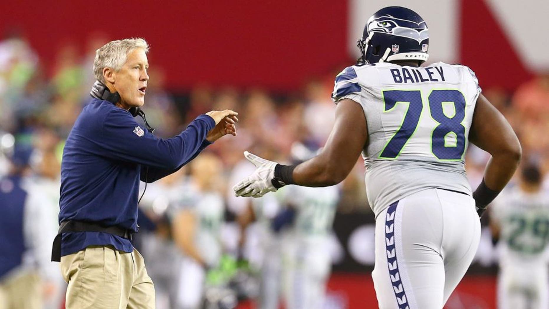 Oct 17, 2013; Phoenix, AZ, USA; Seattle Seahawks head coach Pete Carroll and offensive tackle Alvin Bailey against the Arizona Cardinals at University of Phoenix Stadium. Mandatory Credit: Mark J. Rebilas-USA TODAY Sports