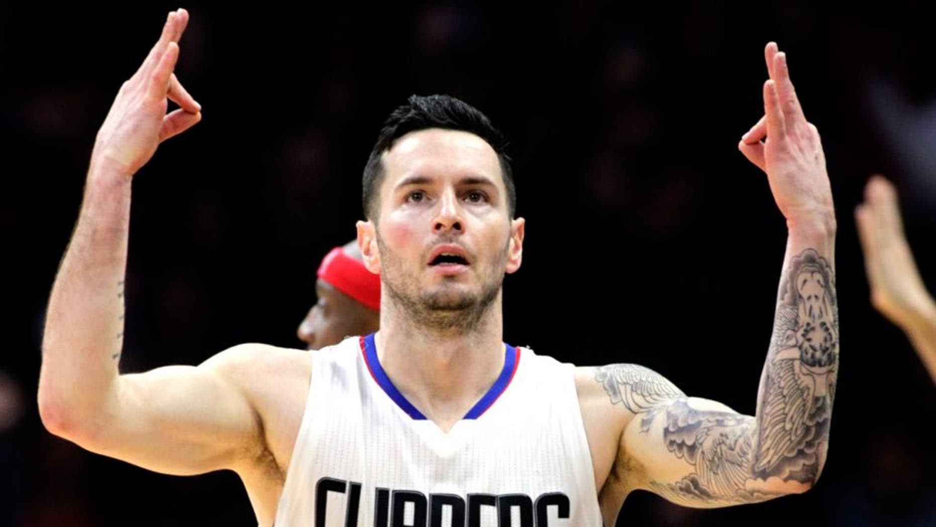 Los Angeles Clippers guard J.J. Redick (4) reacts after making a 3-point shot during the overtime period of an NBA basketball game against the Houston Rockets in Los Angeles, Monday, Jan. 18, 2016. The Clippers won 140-132 in overtime. (AP Photo/Alex Gallardo)