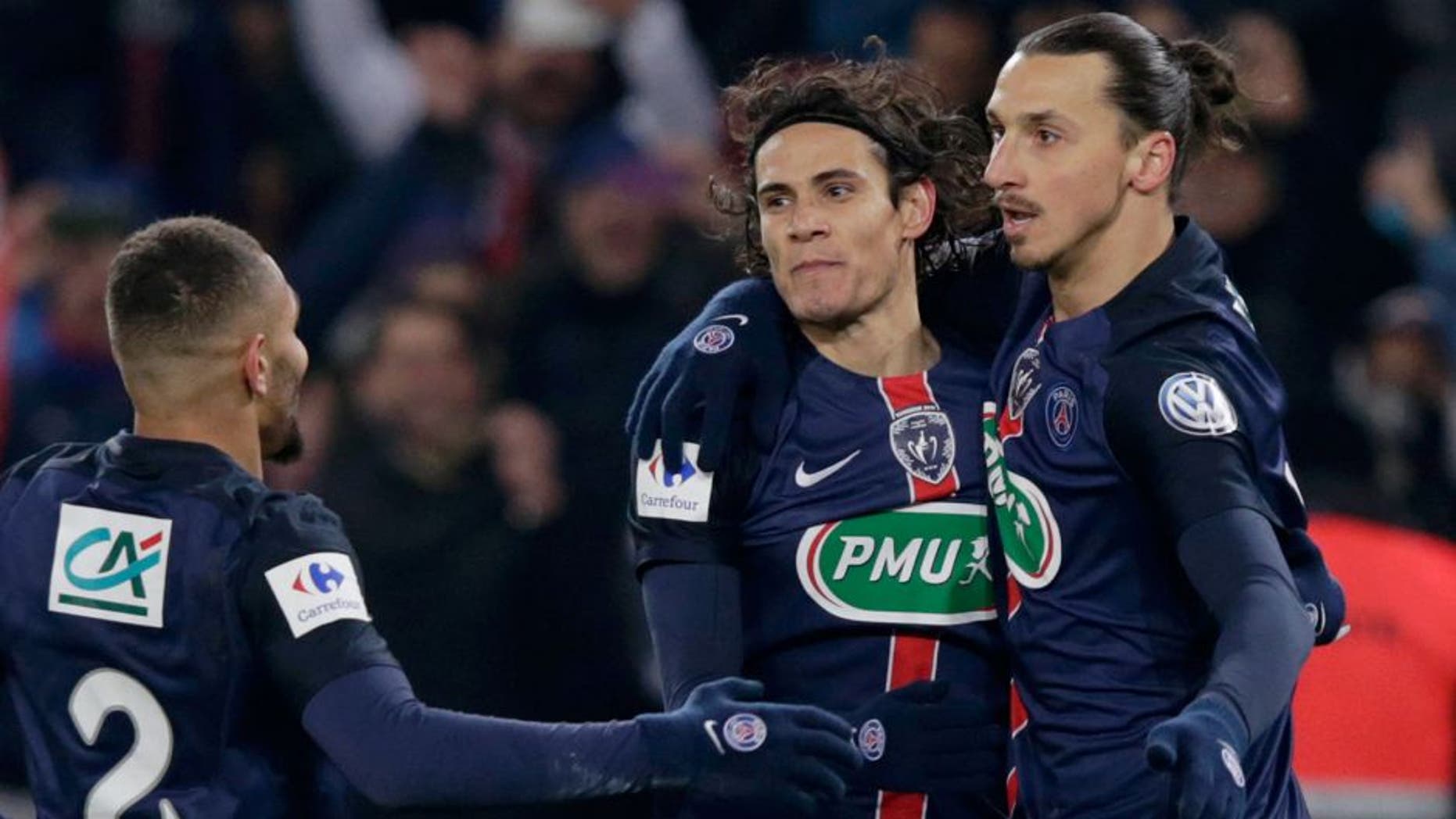 Paris Saint-Germain's Swedish forward Zlatan Ibrahimovic (R) celebrates with Paris Saint-Germain's Uruguayan forward Edinson Cavani (C) after scoring a goal during the French Cup football match between Paris Saint-Germain (PSG) and Toulouse (TFC) on January 19, 2015 at the Parc des Princes stadium, in Paris. AFP PHOTO / KENZO TRIBOUILLARD / AFP / KENZO TRIBOUILLARD (Photo credit should read KENZO TRIBOUILLARD/AFP/Getty Images)