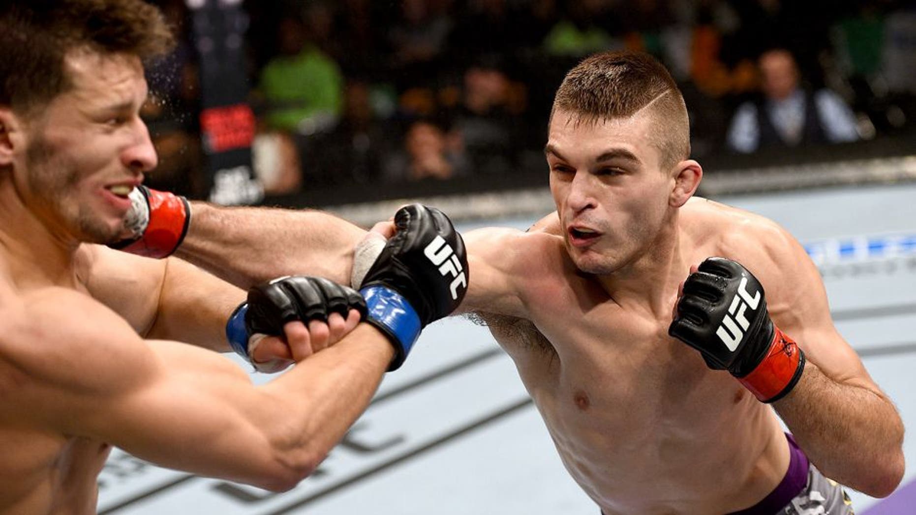 BOSTON, MA - JANUARY 18: (R-L) Johnny Case punches Frankie Perez in their lightweight fight during the UFC Fight Night event at the TD Garden on January 18, 2015 in Boston, Massachusetts. (Photo by Jeff Bottari/Zuffa LLC/Zuffa LLC via Getty Images)