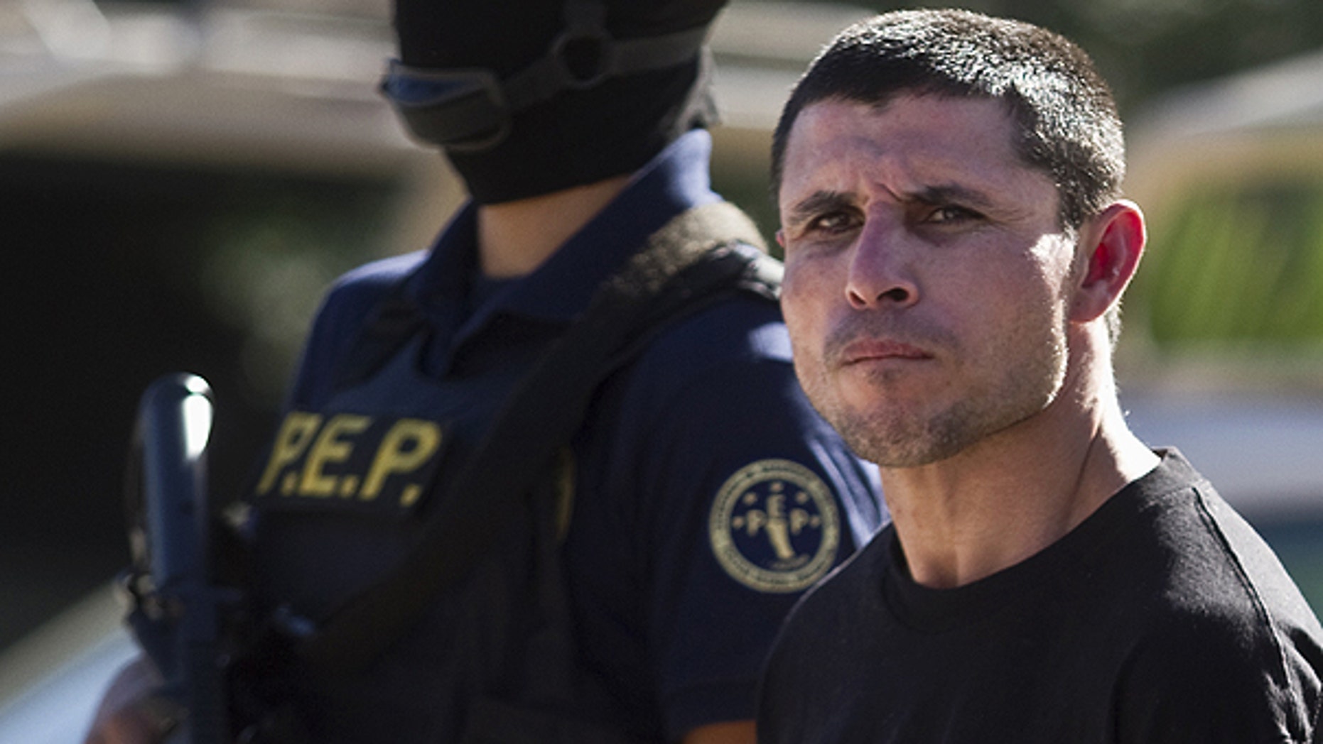 Jan. 20: A suspected member of the Sinaloa drug cartel, Juan Miguel Valle Beltran, right, aka 'El Boxer' is presented to the media in Tijuana, Mexico.