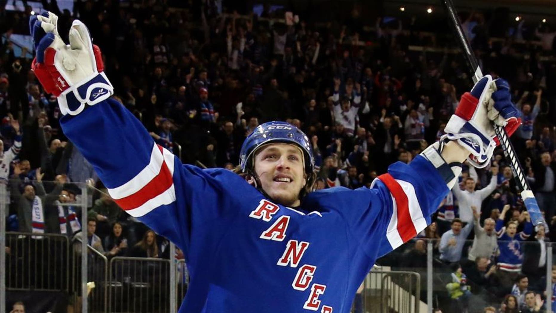 NEW YORK, NY - JANUARY 20: Carl Hagelin #62 of the New York Rangers celebrates his game winning goal against Craig Anderson #41 of the Ottawa Senators to defeat the Ottawa Senators in overtime in their game at Madison Square Garden on January 20, 2015 in New York City. (Photo by Bruce Bennett/Getty Images)