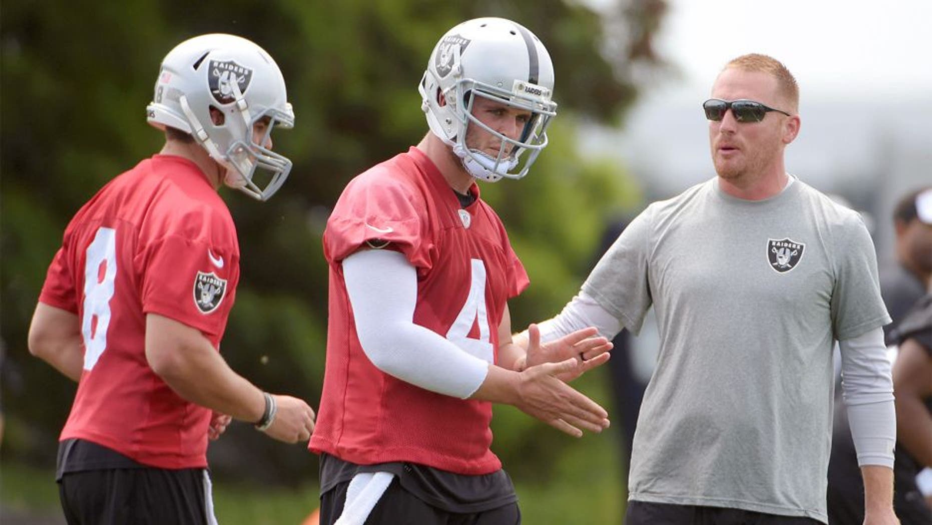 Jun 9, 2015; Oakland, CA, USA; Oakland Raiders quarterbacks coach Todd Downing (right) with quarterbacks Cody Fajardo (8) and Derek Carr (4) at minicamp at the Raiders practice facility. Mandatory Credit: Kirby Lee-USA TODAY Sports