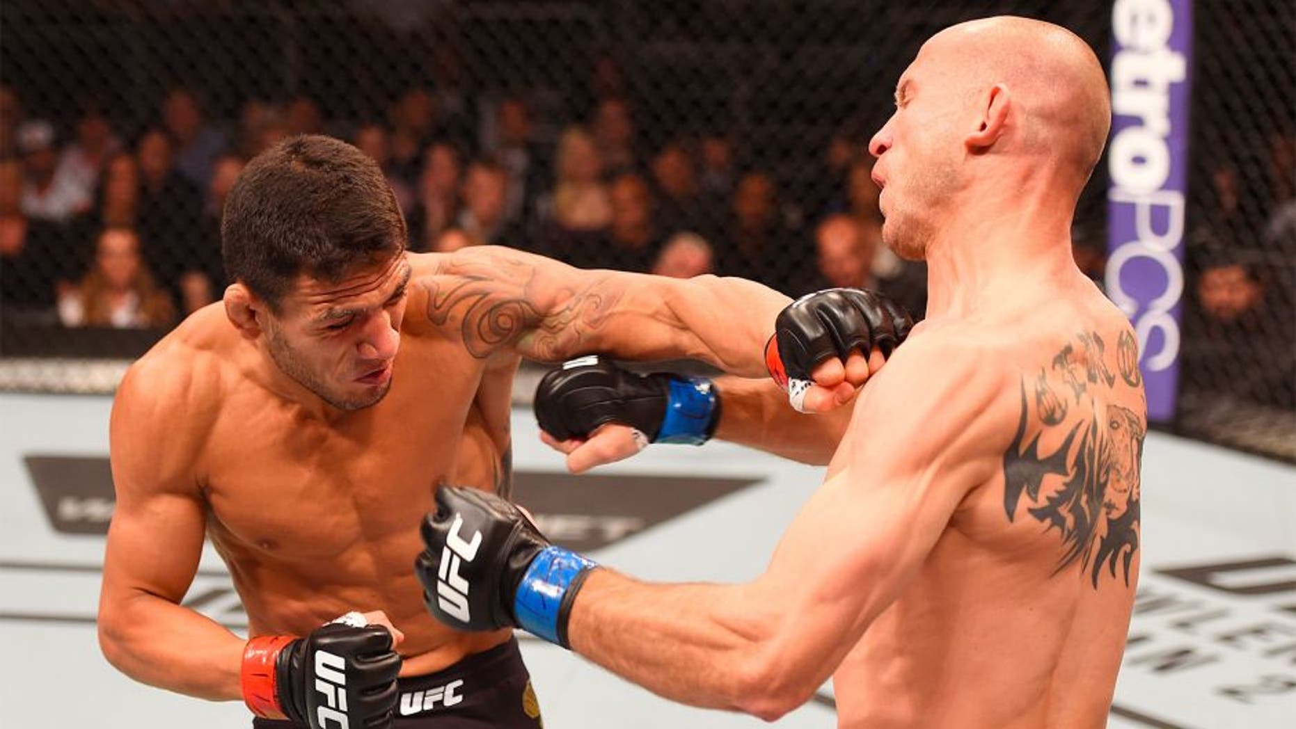 ORLANDO, FL - DECEMBER 19: (L-R) Rafael dos Anjos punches Donald Cerrone in their UFC lightweight title bout during the UFC Fight Night event at the Amway Center on December 19, 2015 in Orlando, Florida. (Photo by Josh Hedges/Zuffa LLC/Zuffa LLC via Getty Images)