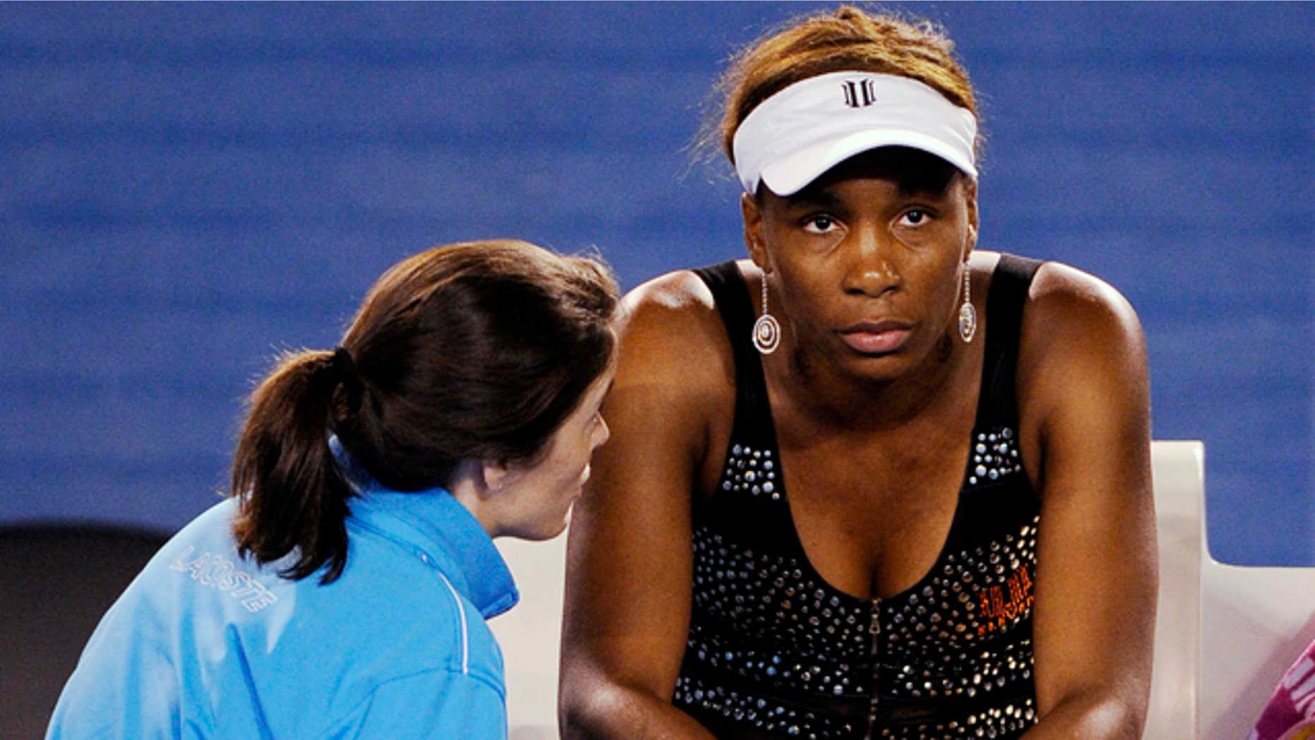 Jan. 21: Venus Williams is spoken to by a trainer before she withdrew from her third round match against Germany's Andrea Petkovic with an injury at the Australian Open tennis championships in Melbourne, Australia.