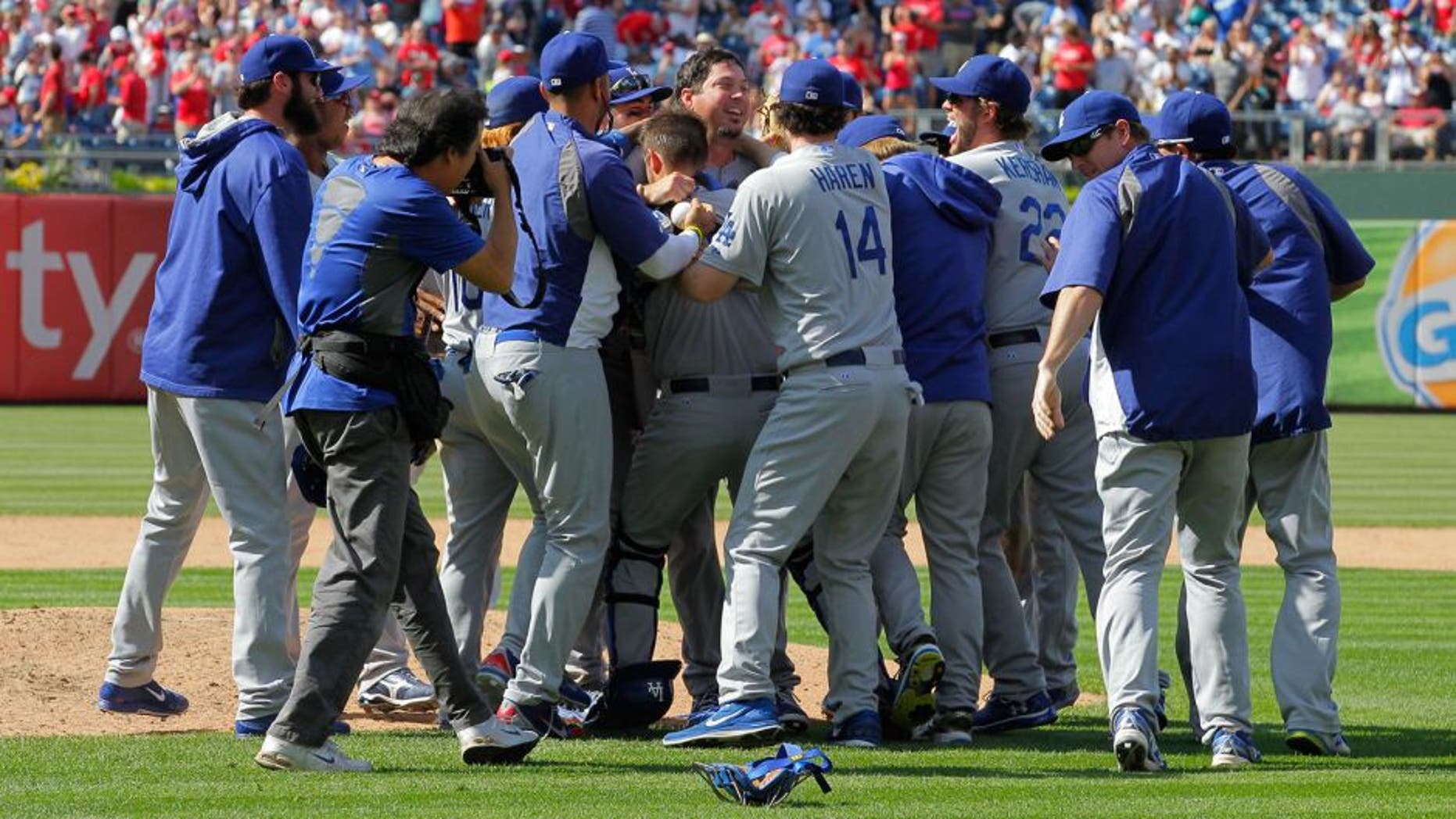 PHILADELPHIA - MAY 25: Starting pitcher Josh Beckett #61 of the Los Angeles Dodgers is swarmed by teammates after throwing a no hitter against the Philadelphia Phillies at Citizens Bank Park on May 25, 2014 in Philadelphia, Pennsylvania. The Dodgers won 6-0. (Photo by Hunter Martin/Getty Images)