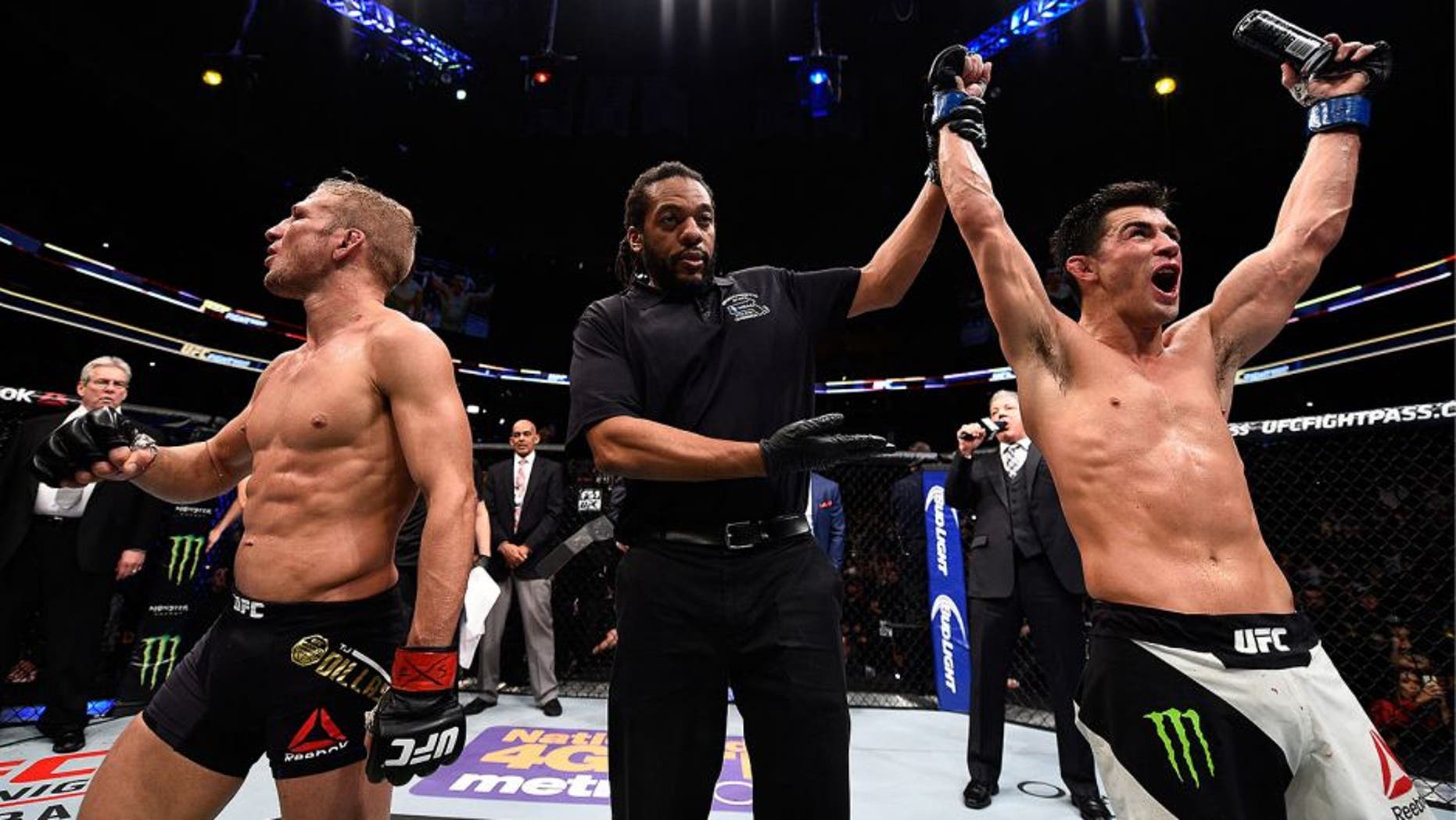 BOSTON, MA - JANUARY 17: Dominick Cruz (R) celebrates his split-decision victory over TJ Dillashaw (L) in their UFC bantamweight championship bout during the UFC Fight Night event inside TD Garden on January 17, 2016 in Boston, Massachusetts. (Photo by Jeff Bottari/Zuffa LLC/Zuffa LLC via Getty Images)