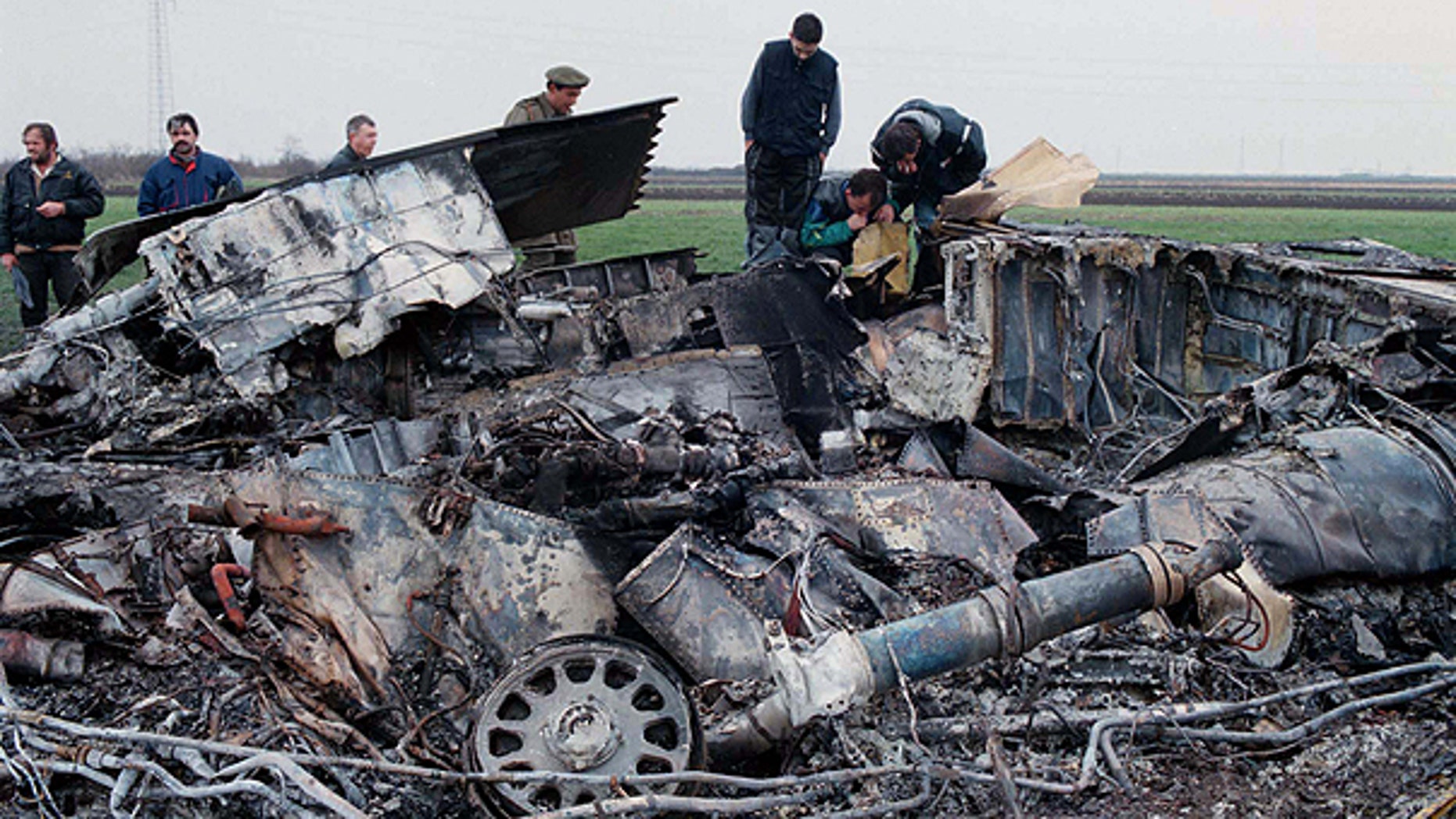 In this March 28, 1999 file photo, Yugoslav army experts check the wreckage of a downed American F-117 aircraft, in the village of Budjanovci, 30 miles northwest of Belgrade.