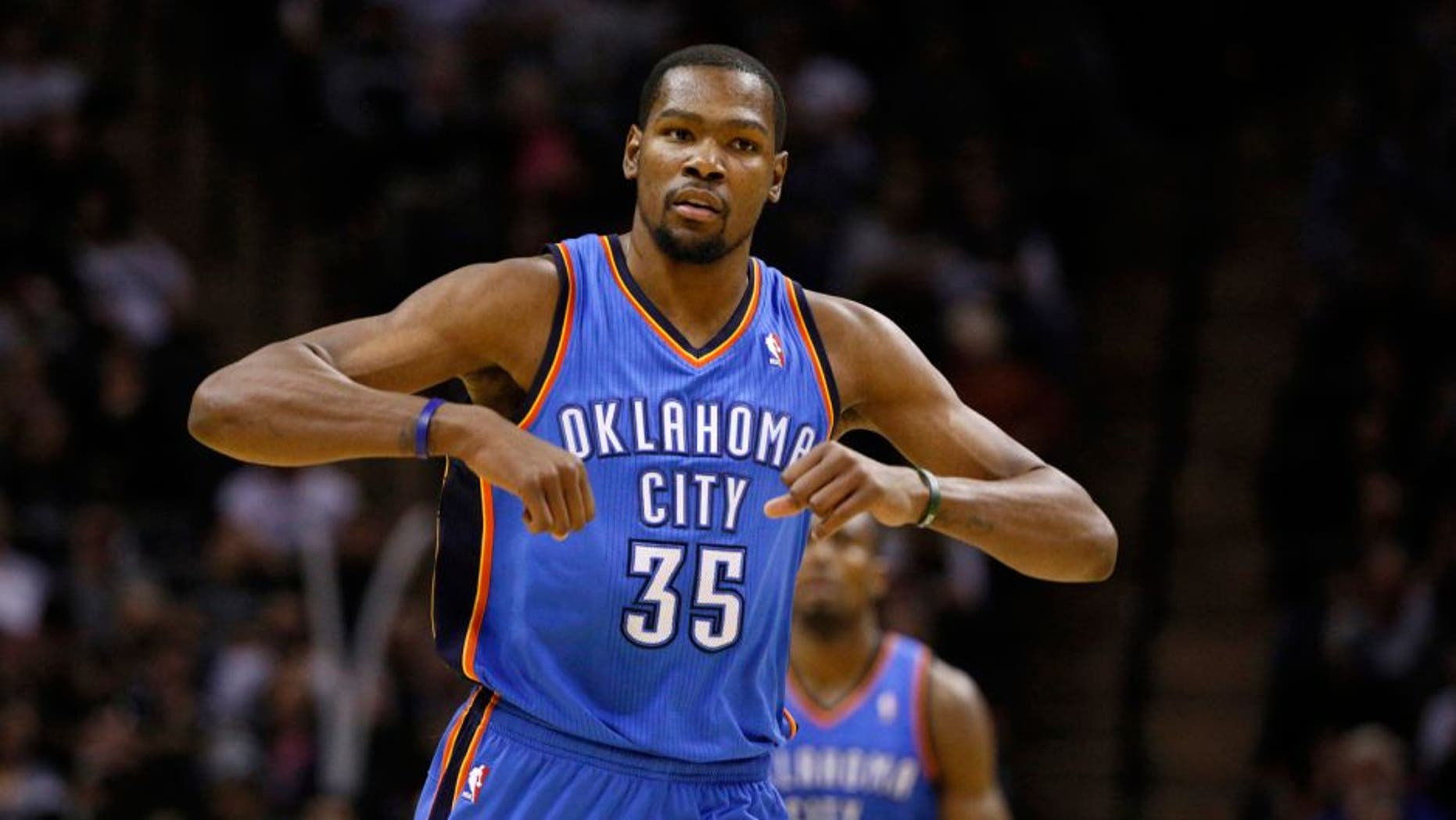 Jan 22, 2014; San Antonio, TX, USA; Oklahoma City Thunder forward Kevin Durant (35) reacts after a shot during the second half against the San Antonio Spurs at AT&T Center. The Thunder won 111-105. Mandatory Credit: Soobum Im-USA TODAY Sports