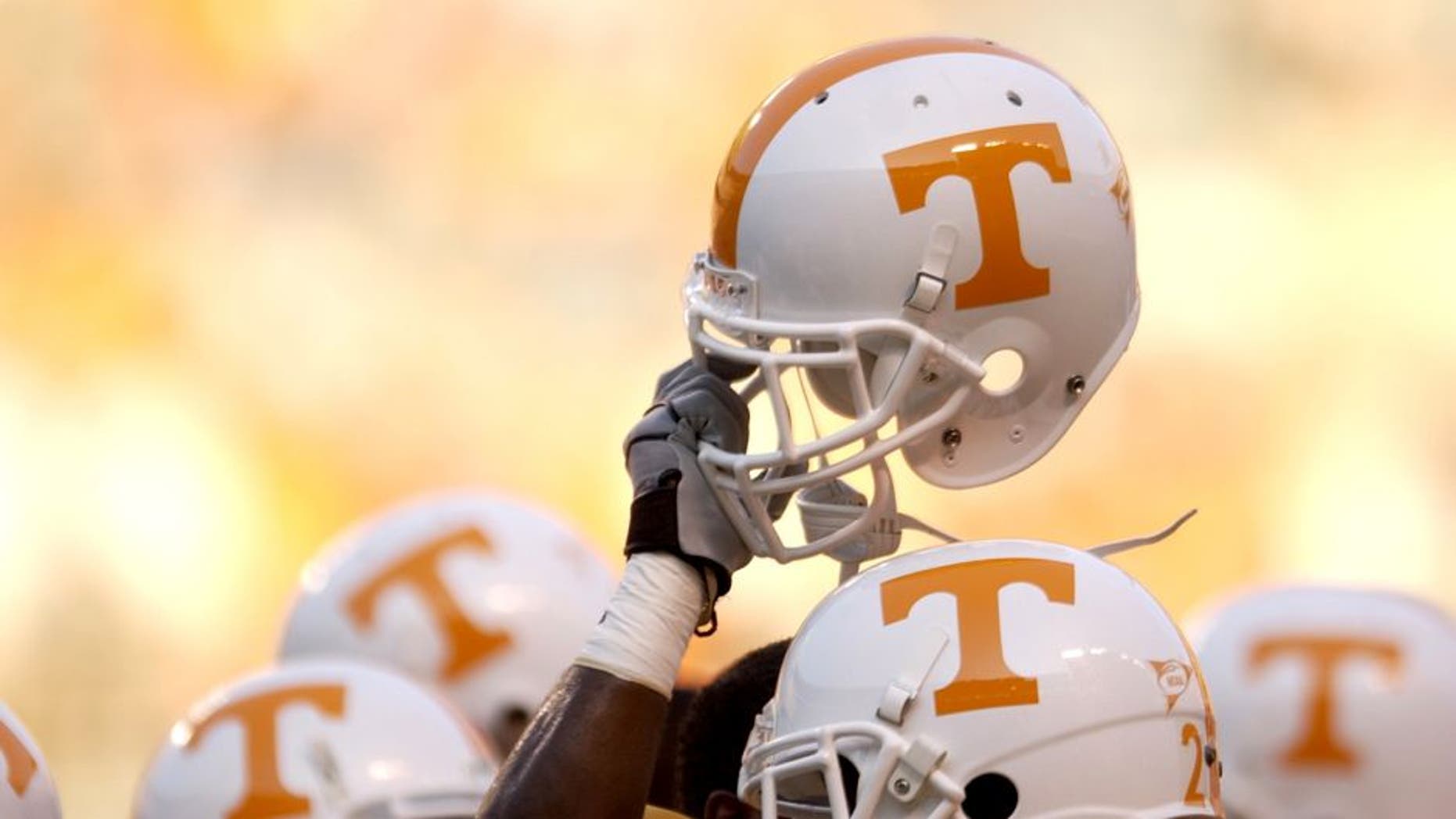 KNOXVILLE, TN - SEPTEMBER 7: A Tennessee Volunteer holds up his helmet in the team huddle before the NCAA football game against the Middle Tennessee State Blue Raiders at Neyland Stadium on September 7, 2002 in Knoxville, Tennessee. Tennessee won 26-3. (Photo by Elsa/Getty Images)