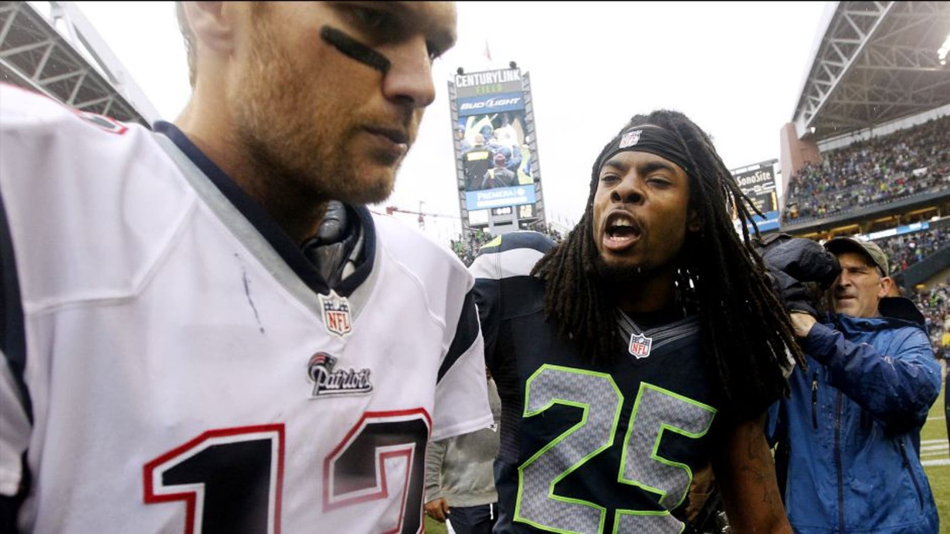 Seattle Seahawks' Richard Sherman (25) talks with New England Patriots quarterback Tom Brady after an NFL football game, Sunday, Oct. 14, 2012, in Seattle. The Seahawks won 24-23. (AP Photo/Elaine Thompson)
