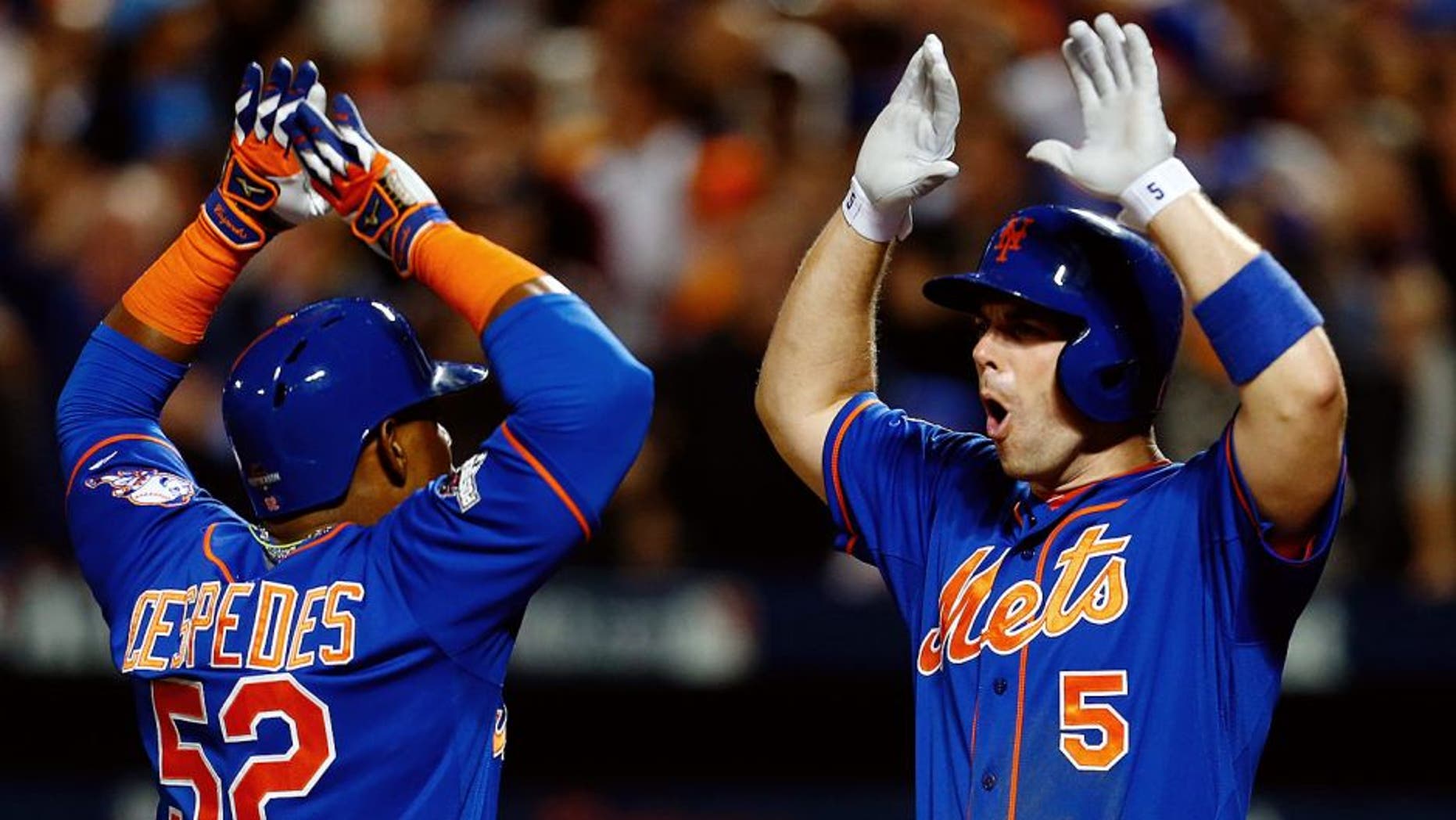 NEW YORK, NY - OCTOBER 12: Yoenis Cespedes #52 of the New York Mets celebrates with David Wright #5 after hitting a three run home run against Alex Wood #57 of the Los Angeles Dodgers in the fourth inning during game three of the National League Division Series at Citi Field on October 12, 2015 in New York City. (Photo by Mike Stobe/Getty Images)