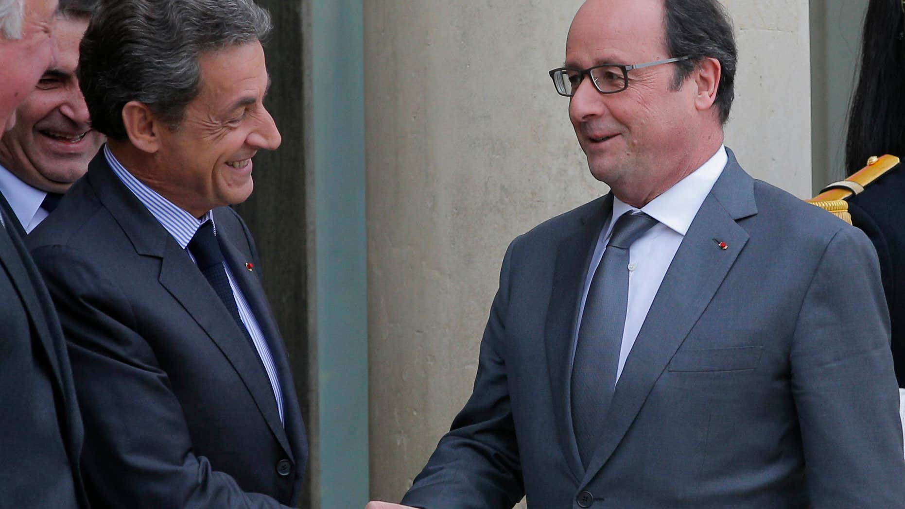 Jan. 22, 2016: French President Francois Hollande, right, shakes hands with Nicolas Sarkozy, former French President and head of the conservative "Les Republicains" party, after a meeting at the Elysee Palace, in Paris.