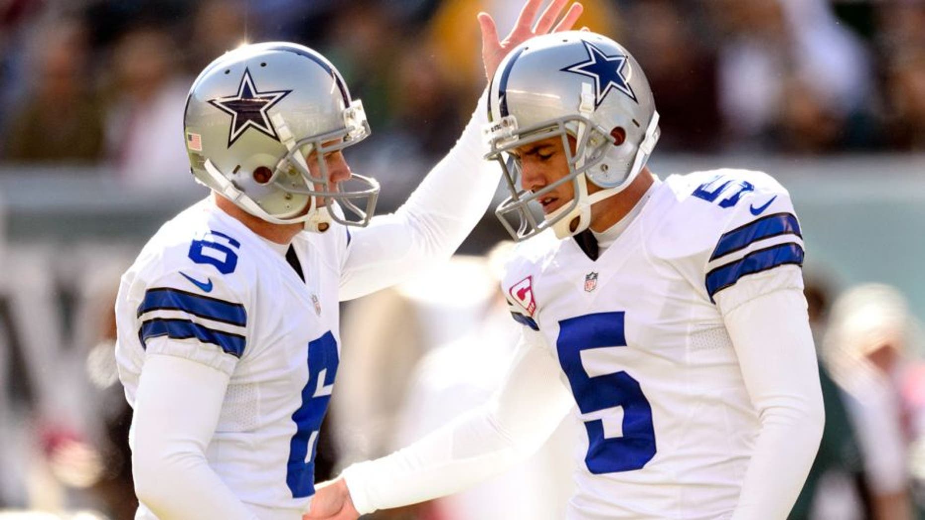 Oct 20, 2013; Philadelphia, PA, USA; Dallas Cowboys place kicker Dan Bailey (5) celebrates kicking a field goal with holder Chris Jones (6) during the second quarter against the Philadelphia Eagles at Lincoln Financial Field. Mandatory Credit: Howard Smith-USA TODAY Sports