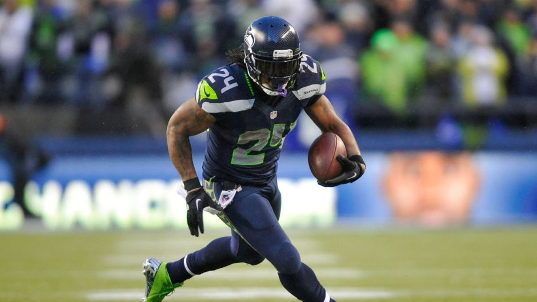 Jan 11, 2014; Seattle, WA, USA; Seattle Seahawks running back Marshawn Lynch (24) carries the ball against the New Orleans Saints during the second half of the 2013 NFC divisional playoff football game at CenturyLink Field. Seattle defeated New Orleans 23-15. Mandatory Credit: Steven Bisig-USA TODAY Sports