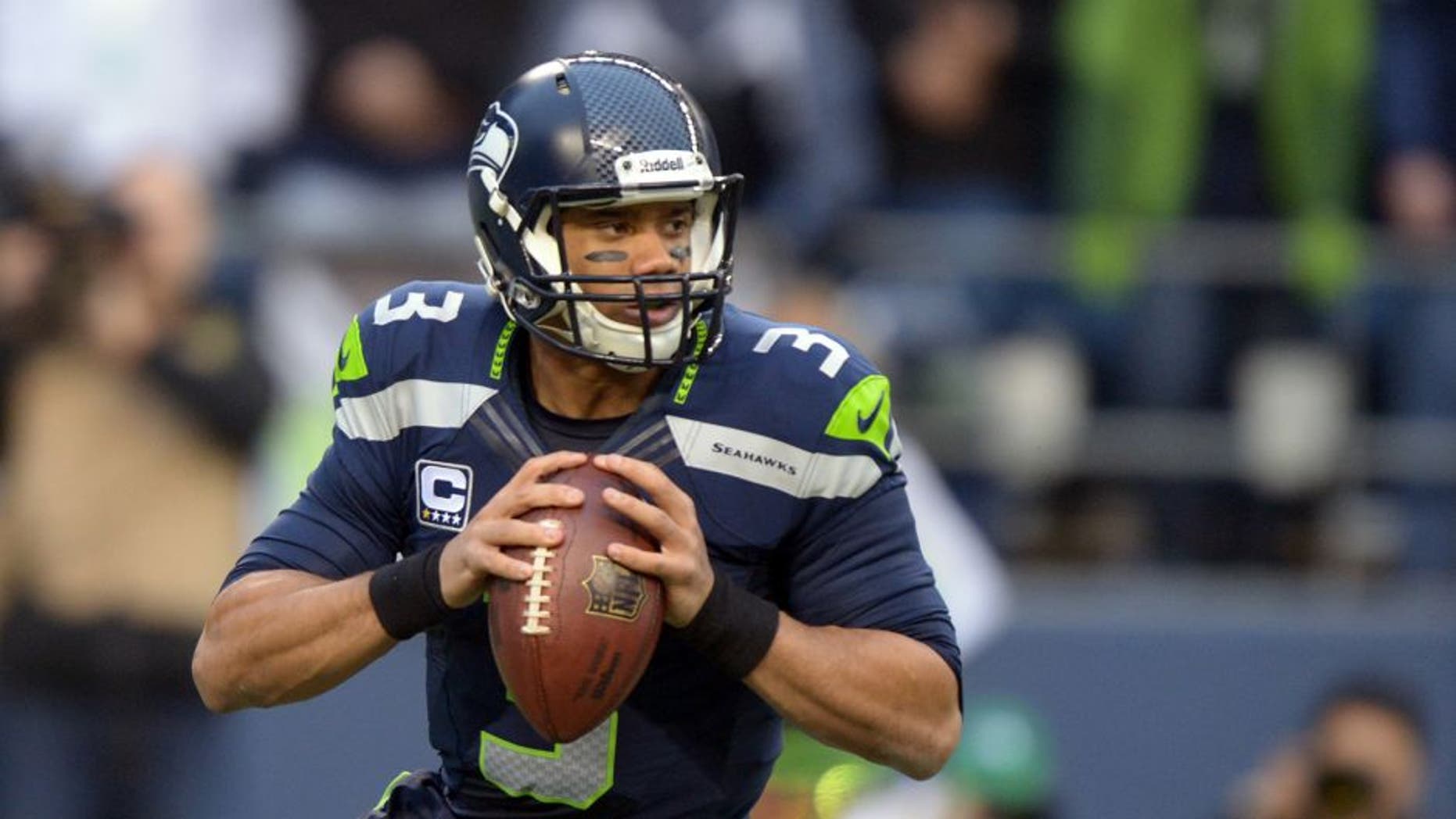 Jan 19, 2014; Seattle, WA, USA; Seattle Seahawks quarterback Russell Wilson (3) drops back to pass against the San Francisco 49ers during the first half of the 2013 NFC Championship football game at CenturyLink Field. Mandatory Credit: Kirby Lee-USA TODAY Sports
