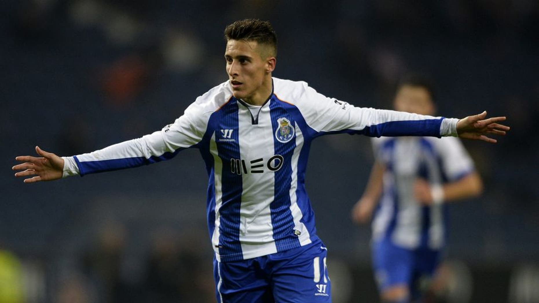 Porto's Spanish forward Cristian Tello celebrates with teammates after scoring a goal during the Portuguese league football match FC Porto v FC Pacos de Ferreira at the Dragao stadium in Porto on February 1, 2015. AFP PHOTO / MIGUEL RIOPA (Photo credit should read MIGUEL RIOPA/AFP/Getty Images)