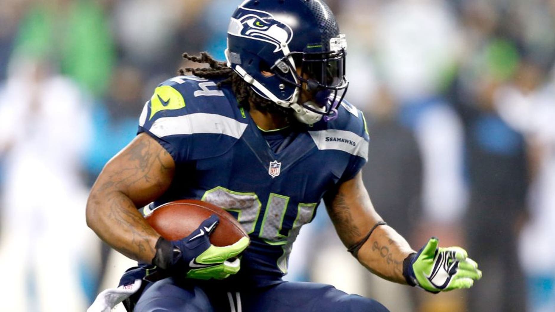 SEATTLE, WA - JANUARY 10: Marshawn Lynch #24 of the Seattle Seahawks runs the ball against the Carolina Panthers during the 2015 NFC Divisional Playoff game at CenturyLink Field on January 10, 2015 in Seattle, Washington. (Photo by Otto Greule Jr/Getty Images)