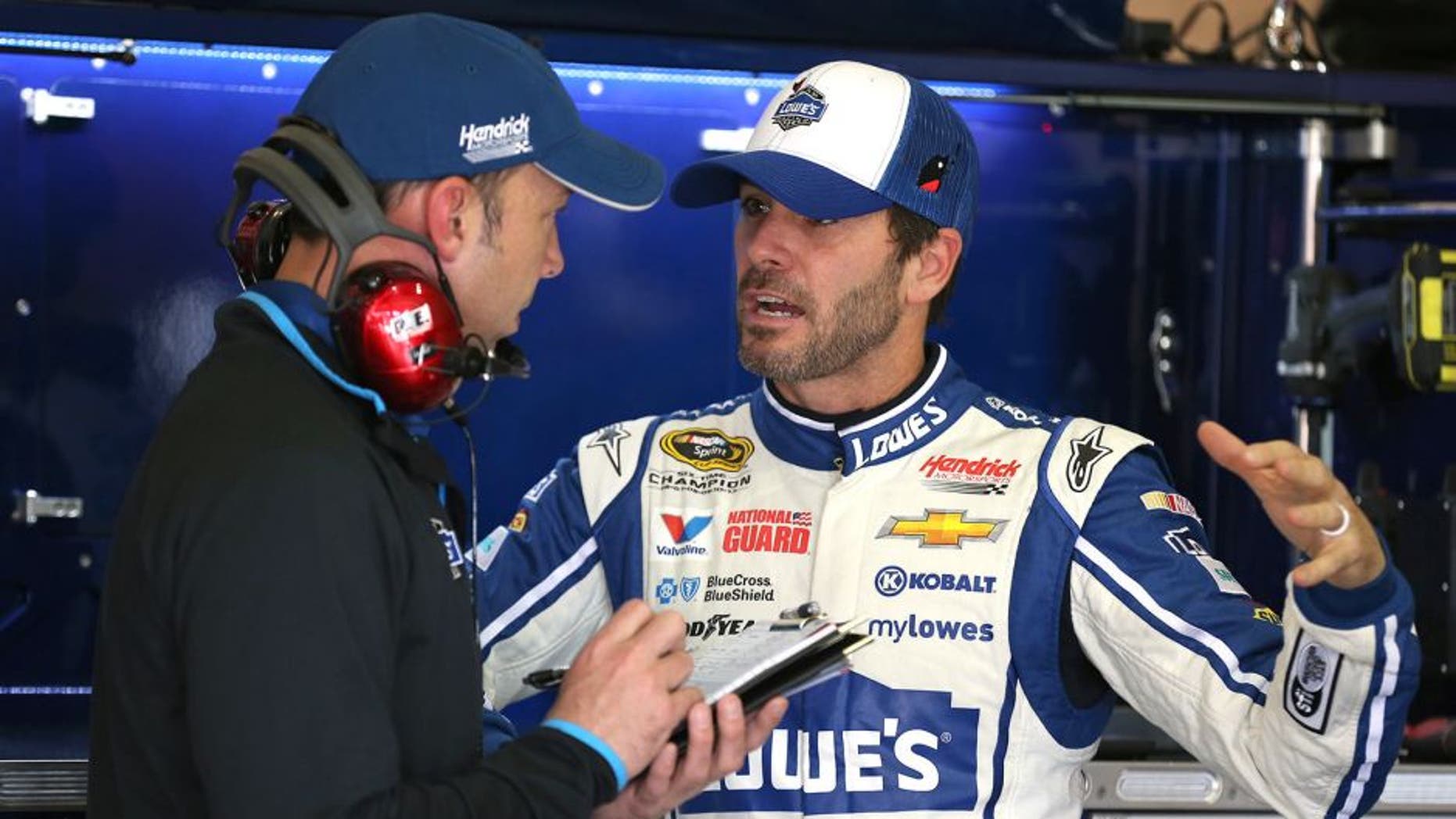 FONTANA, CA - MARCH 21: Jimmie Johnson (right), driver of the #48 Lowe's Chevrolet, speaks with crew chief Chad Knaus during practice for the NASCAR Sprint Cup Series Auto Club 400 at Auto Club Speedway on March 21, 2014 in Fontana, California. (Photo by Robert Laberge/Getty Images)
