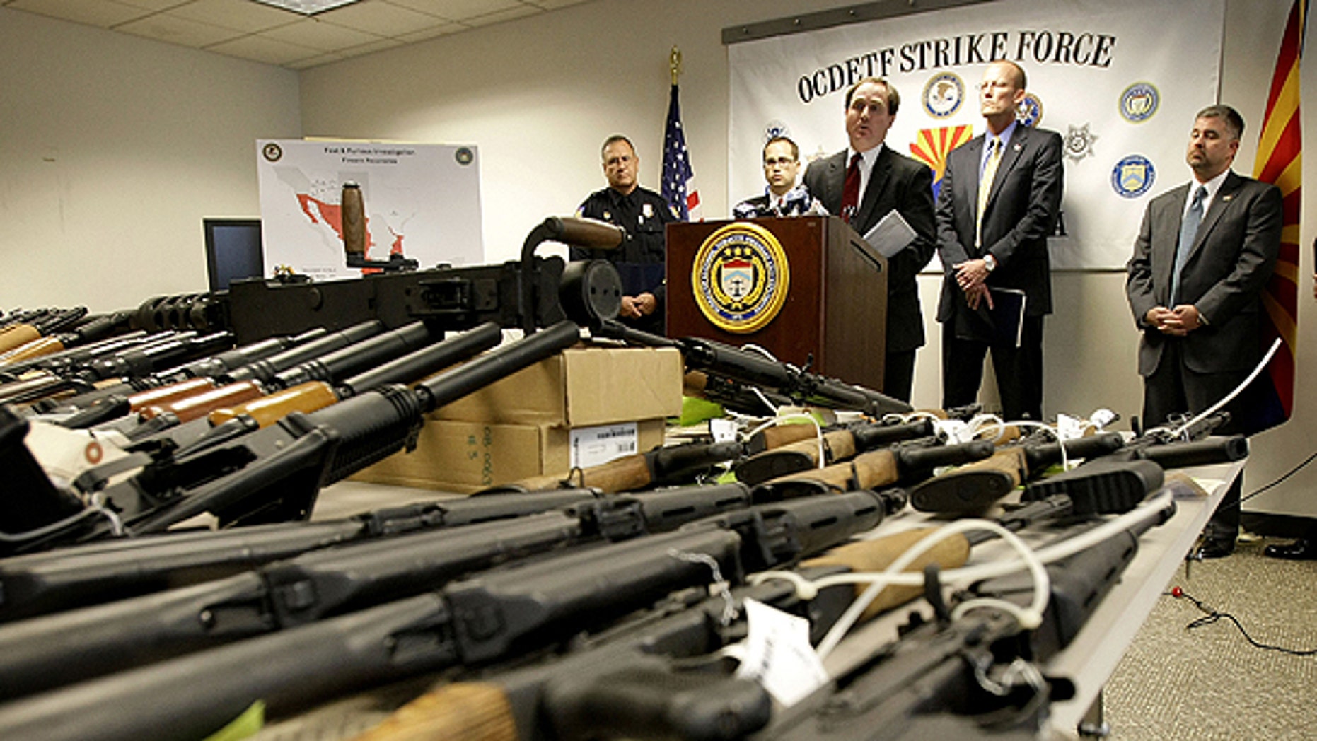 Jan. 25: United States Attorney for Arizona Dennis Burke speaks behind a cache of seized weapons in Phoenix.