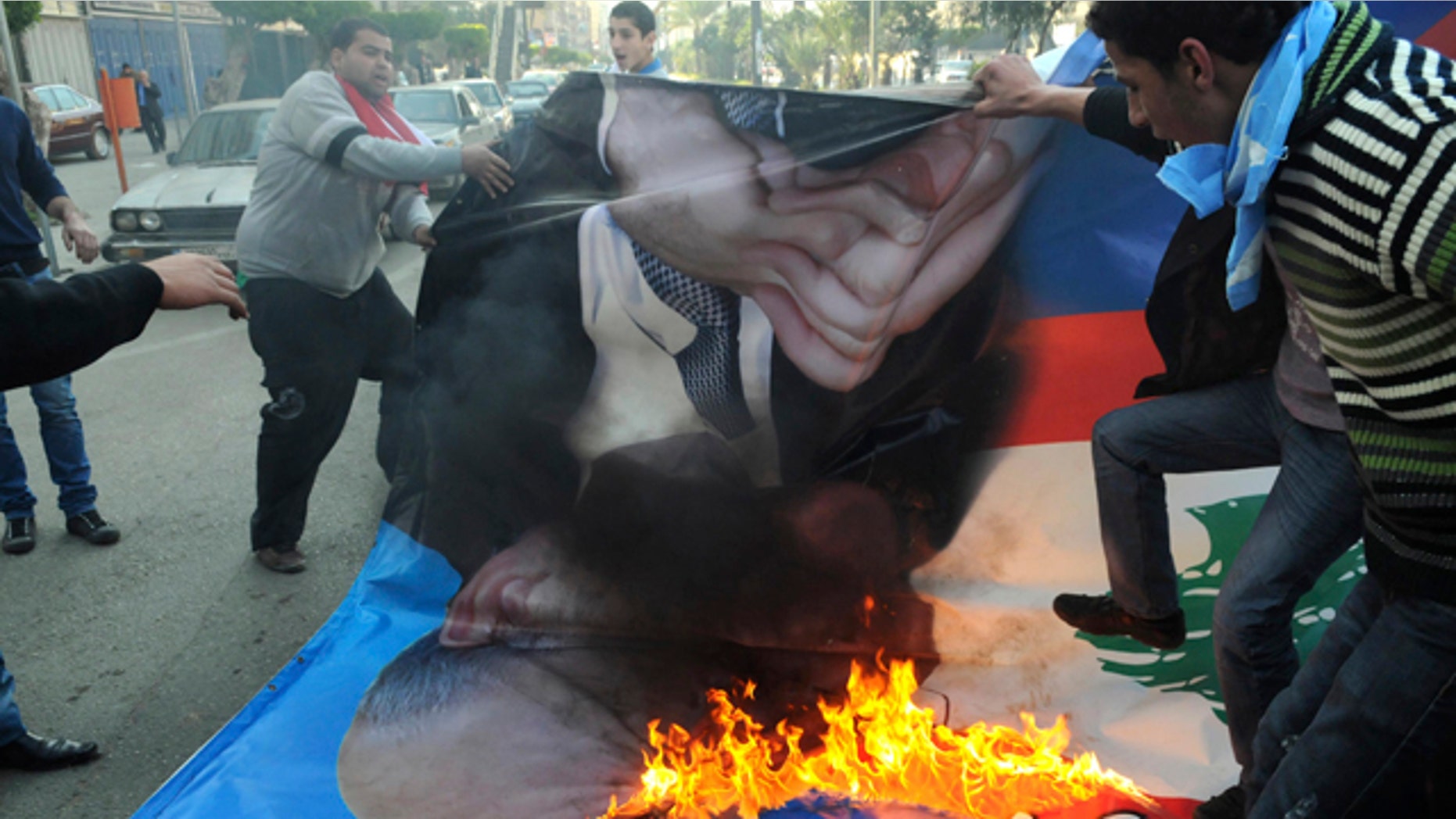 Jan. 25: Angry Sunni protesters burn a poster of former premier Najib Mikati in the northern port city of Tripoli, Lebanon.