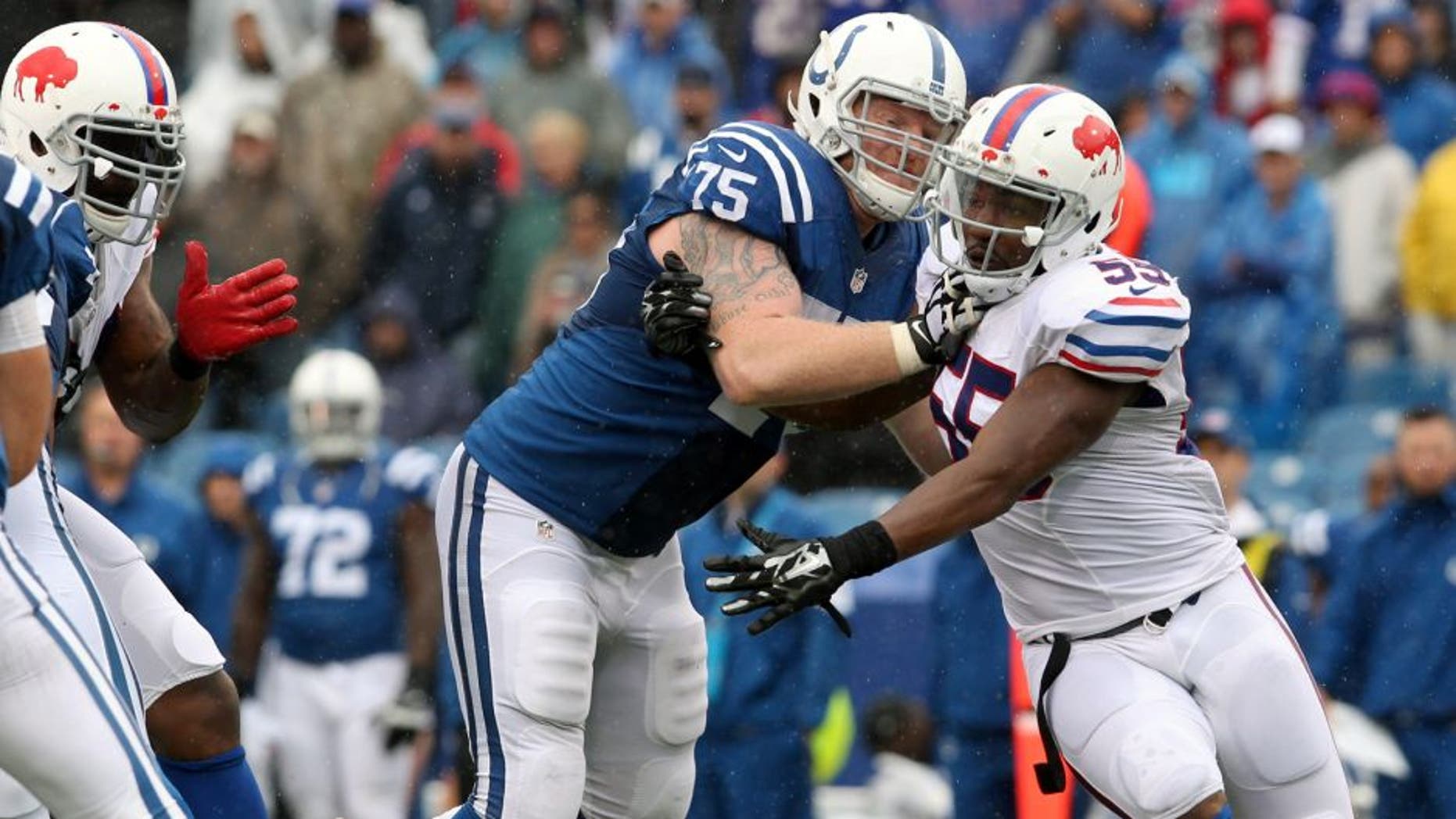 Sep 13, 2015; Orchard Park, NY, USA; Indianapolis Colts guard Jack Mewhort (75) tries to block Buffalo Bills defensive end Jerry Hughes (55) during the second half at Ralph Wilson Stadium. Bills beat the Colts 27 to 14. Mandatory Credit: Timothy T. Ludwig-USA TODAY Sports