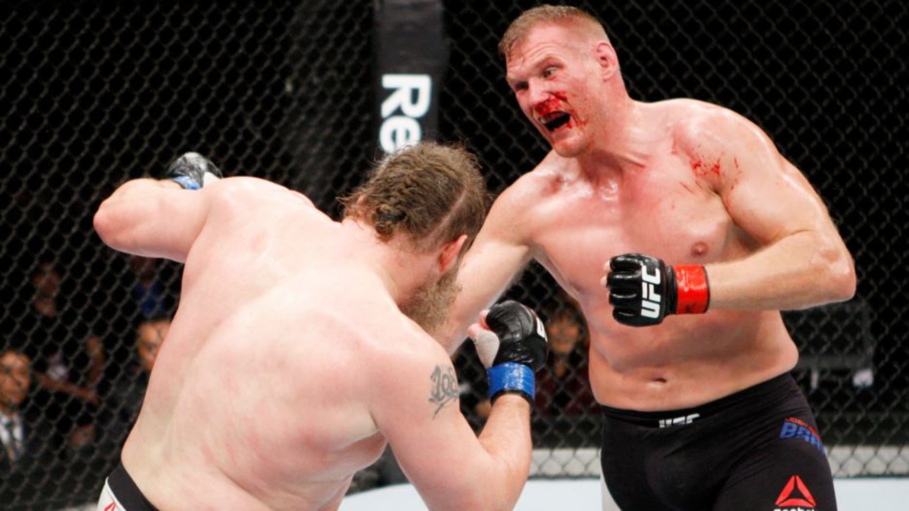 SAITAMA, JAPAN - SEPTEMBER 27: (From L to R) Roy Nelson of the United States of America and Josh Barnett of the United States of America exchange punches in their heavyweight bout during the UFC event at the Saitama Super Arena on September 27, 2015 in Saitama, Japan. (Photo by Mitch Viquez/Zuffa LLC/Zuffa LLC via Getty Images)