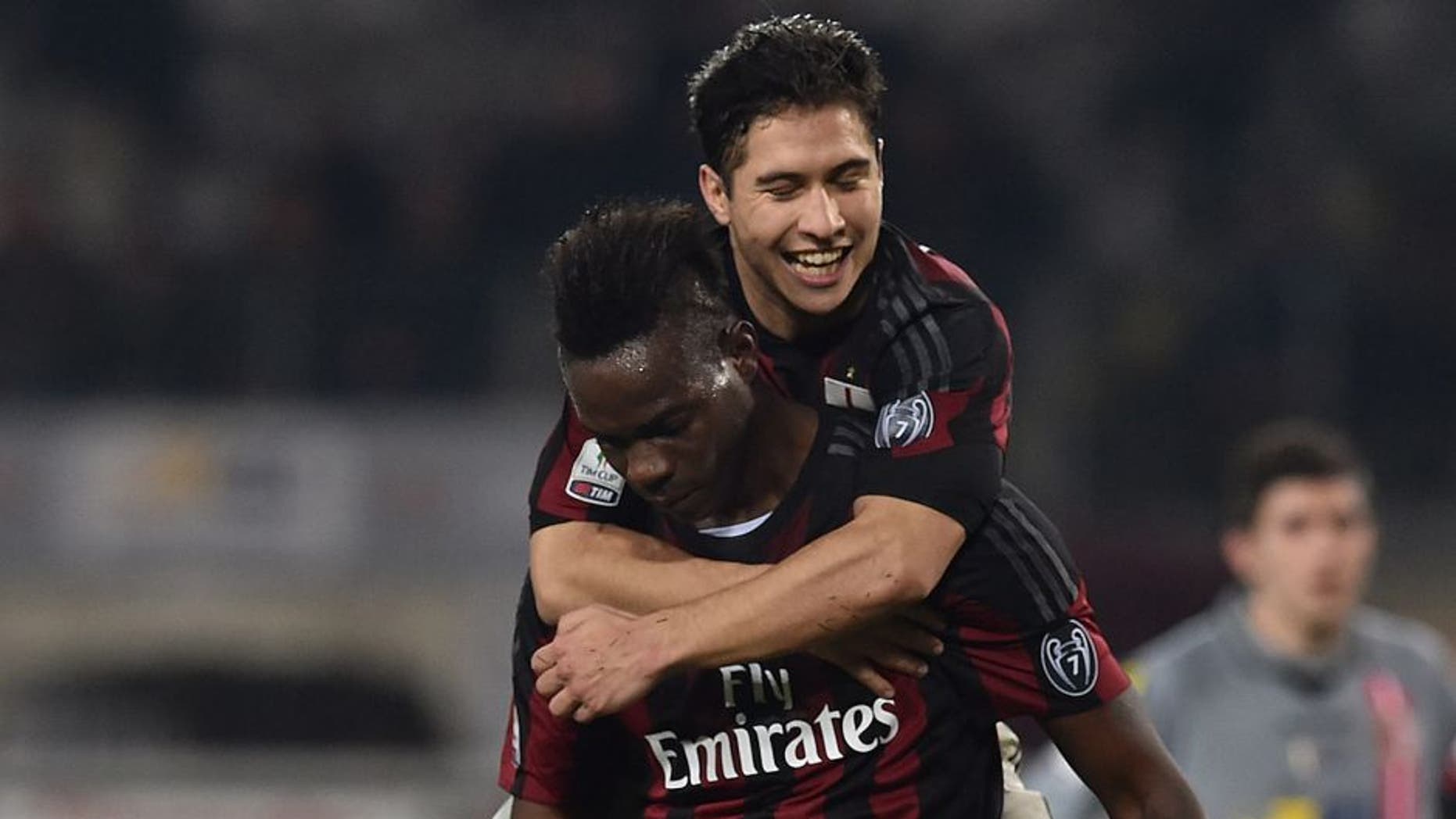 TURIN, ITALY - JANUARY 26: Mario Balotelli (C) of AC Milan celebrates after scoring the opening goal from the penalty spot with team mate Jose Mauri during the TIM Cup match between US Alessandria and AC Milan at Olimpico Stadium on January 26, 2016 in Turin, Italy. (Photo by Valerio Pennicino/Getty Images)
