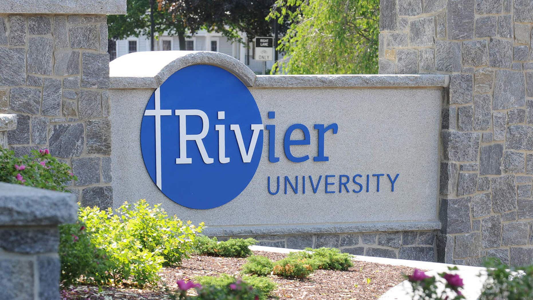 In this undated handout photo provided by Rivier University, the colleges' sign is seen at the entrance to the campus in Nashua, N.H.