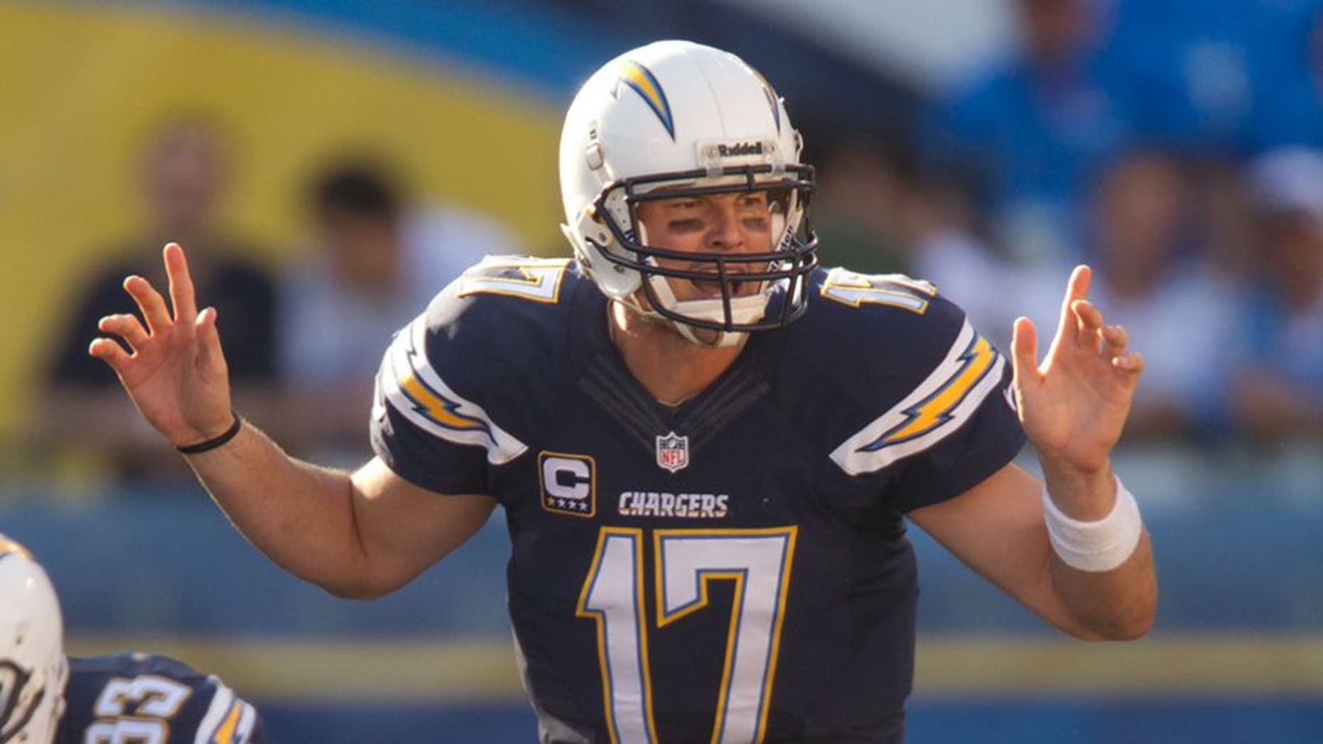 Dec 29, 2013; San Diego, CA, USA; San Diego Chargers quarterback Philip Rivers (17) comes to the line during the Chargers 27-24 overtime win against the Kansas City Chiefs at Qualcomm Stadium. Mandatory Credit: Stan Liu-USA TODAY Sports