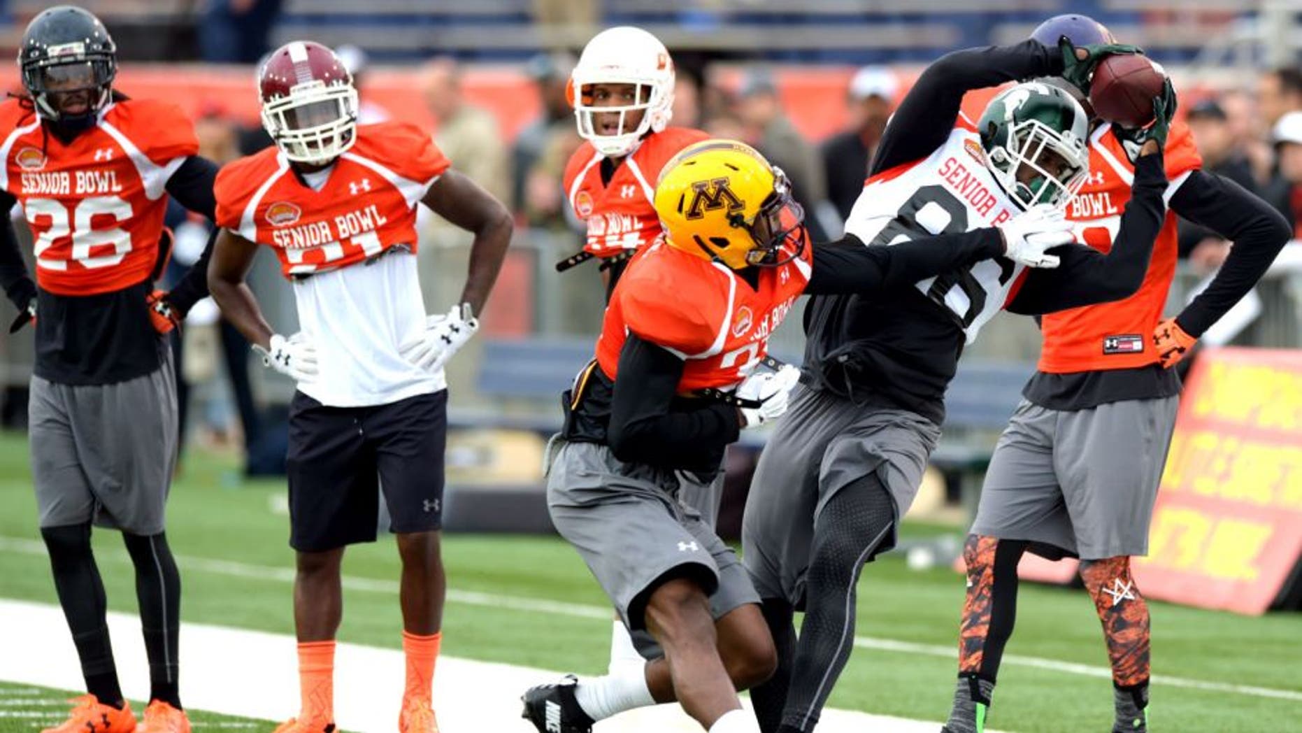 Jan 26, 2016; Mobile, AL, USA; North squad wide receiver Aaron Burbridge of Michigan State (86) makes a catch near the sideline as defensive back Eric Murray of Minnesota (31) defends during Senior Bowl practice at Ladd-Peebles Stadium. Mandatory Credit: Glenn Andrews-USA TODAY Sports